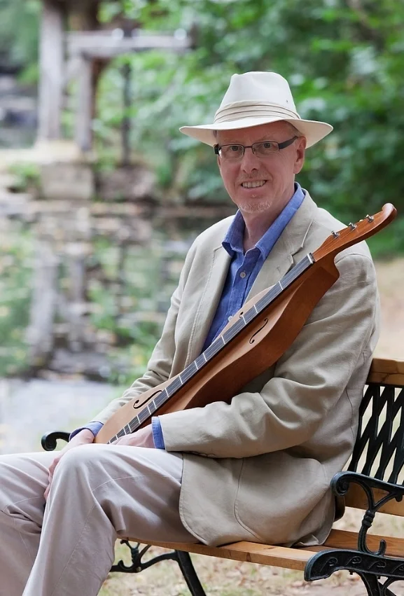 Dan seated with dulcimer and hat.jpg