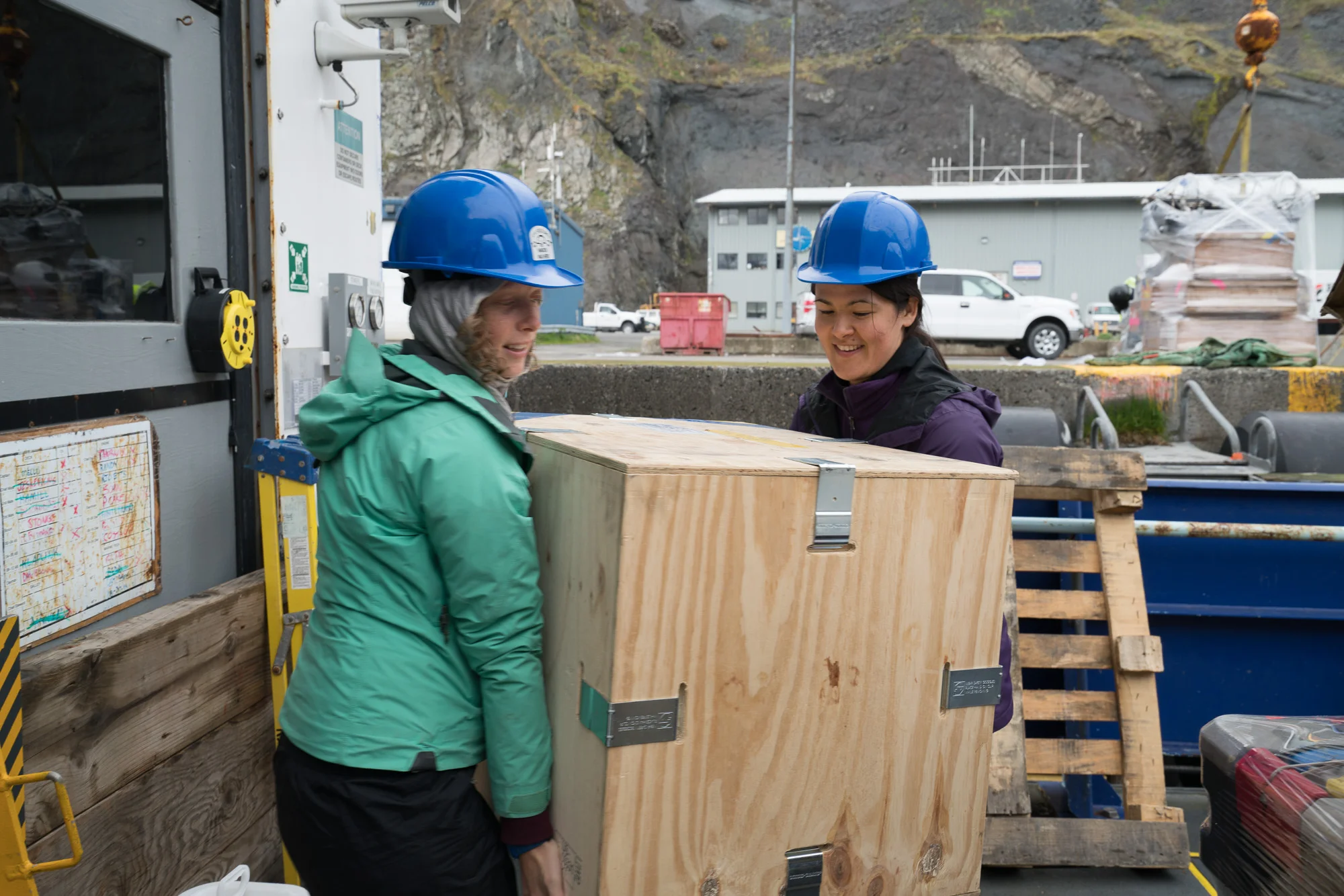 Stephanie and Rachel carry gear into the lab. Photo credit: Andrew McDonnell
