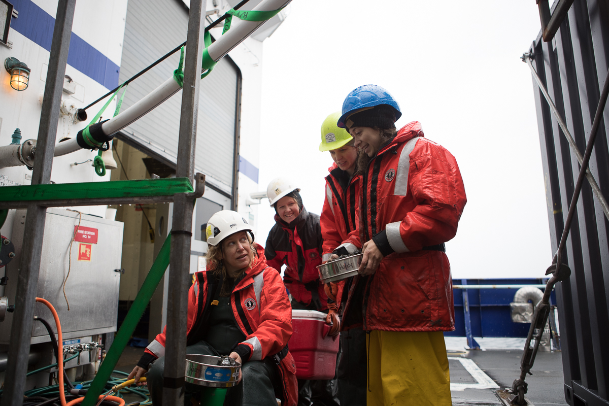 Sarah Hardy and her sediment team filtering out the first multi-core sample of the Arctic Program. Photo credit: Brendan Smith