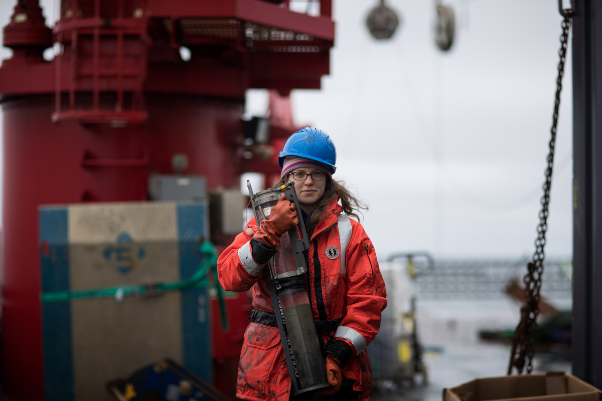 Brittany Jones carrying a sediment core after a recent multi-core deployment. Photo credit: Brendan Smith