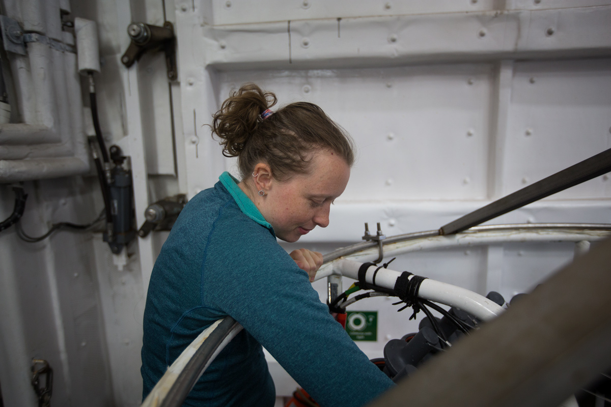 Stephanie climbing on the CTD rosette to get to some of the equipment for the UVP. Photo credit: Brendan Smith