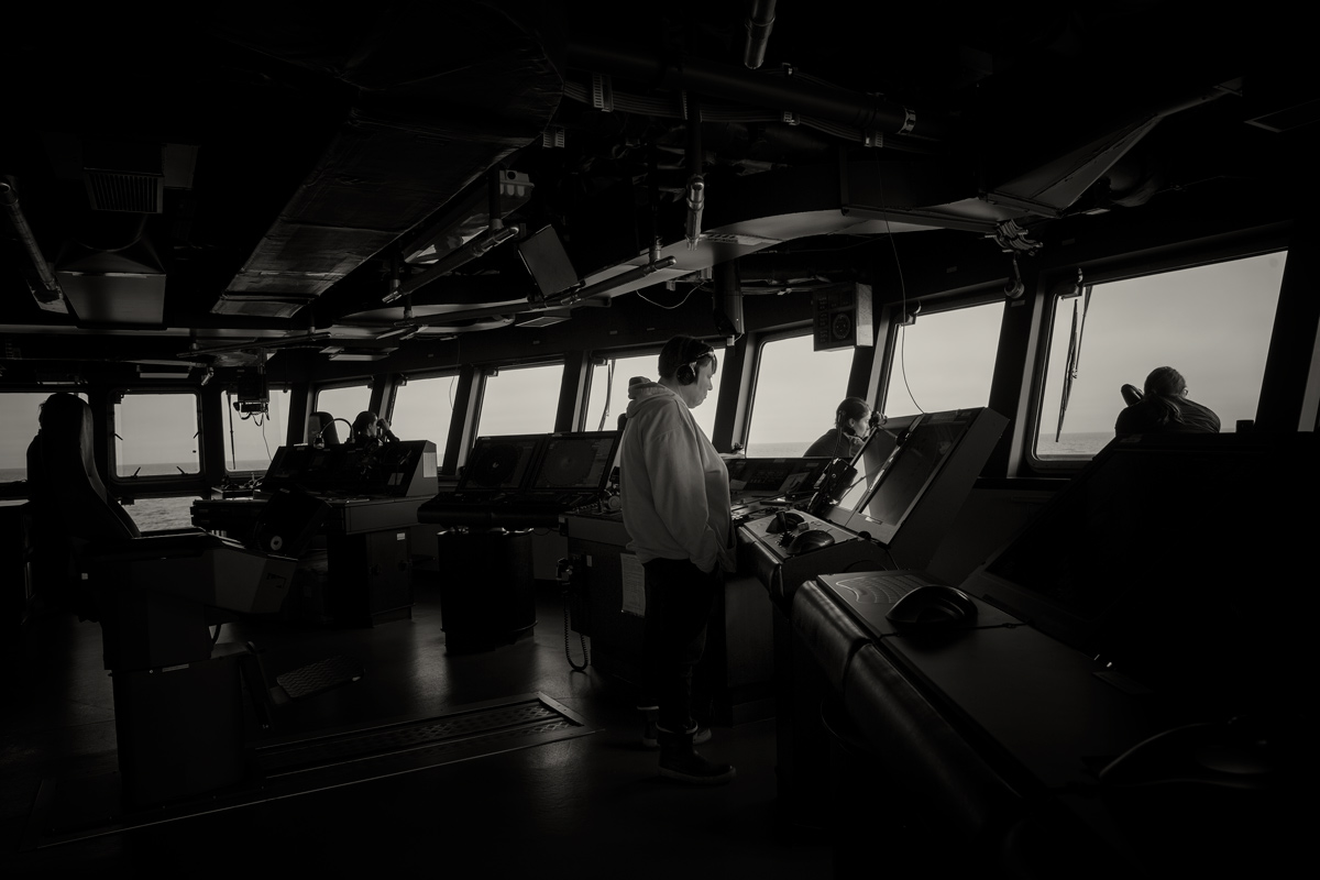 During a search and rescue operation for two boys from Diomede/Wales, Opik tirelessly stands watch on the bridge with fellow lookouts from the research team. Photo credit: Brendan Smith