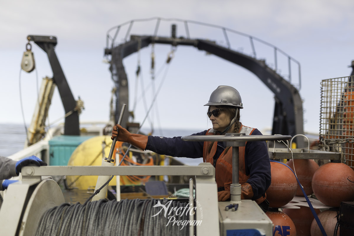Catherine Berchok guiding the dragging wire back into the spool of the winch. Photo credit: Brendan Smith/NPRB
