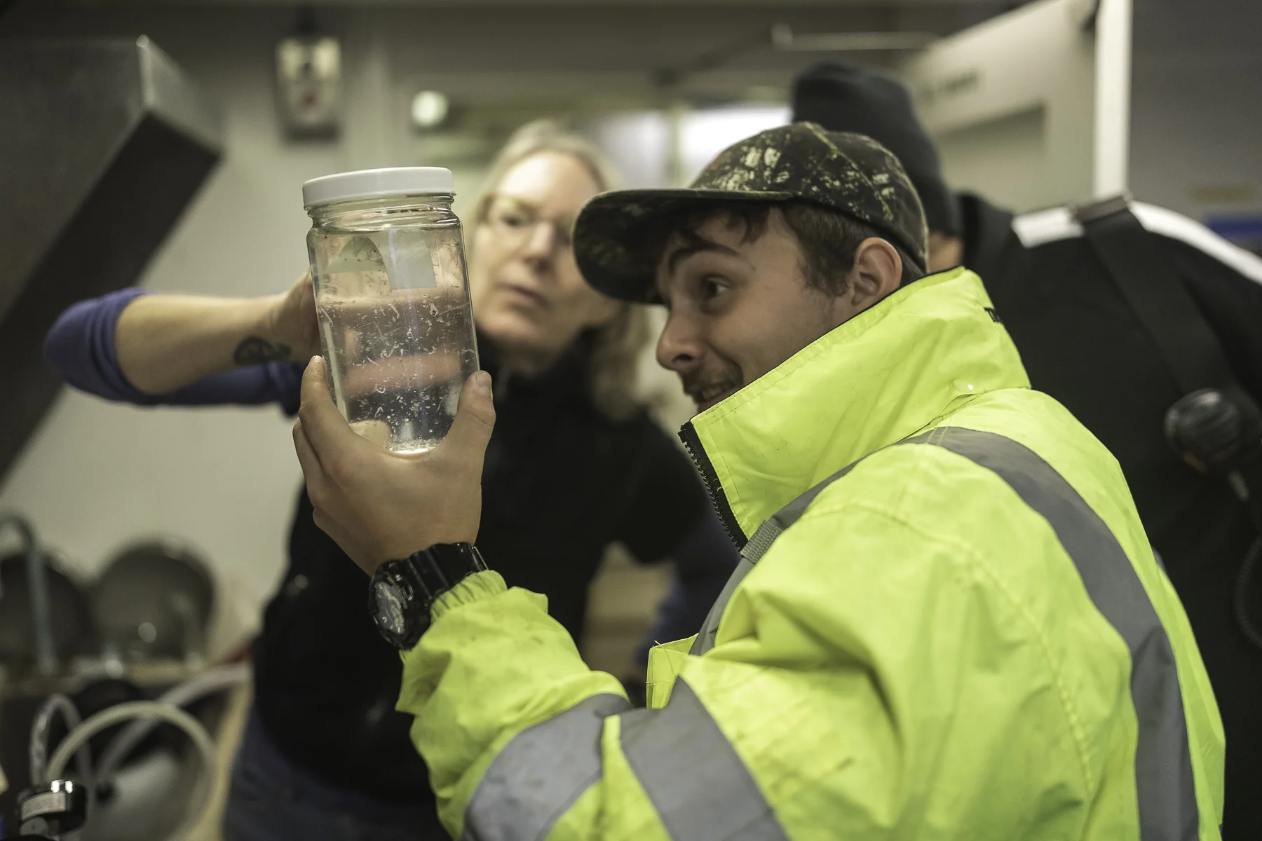 Libby Logerwell (background) shows one of the AB’s, Austin, a recent sample from the bongo net. Photo by Brendan Smith/NPRB.