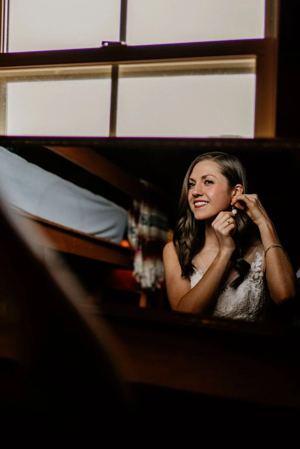 Ranch-Style Micro Wedding Bride putting on earrings