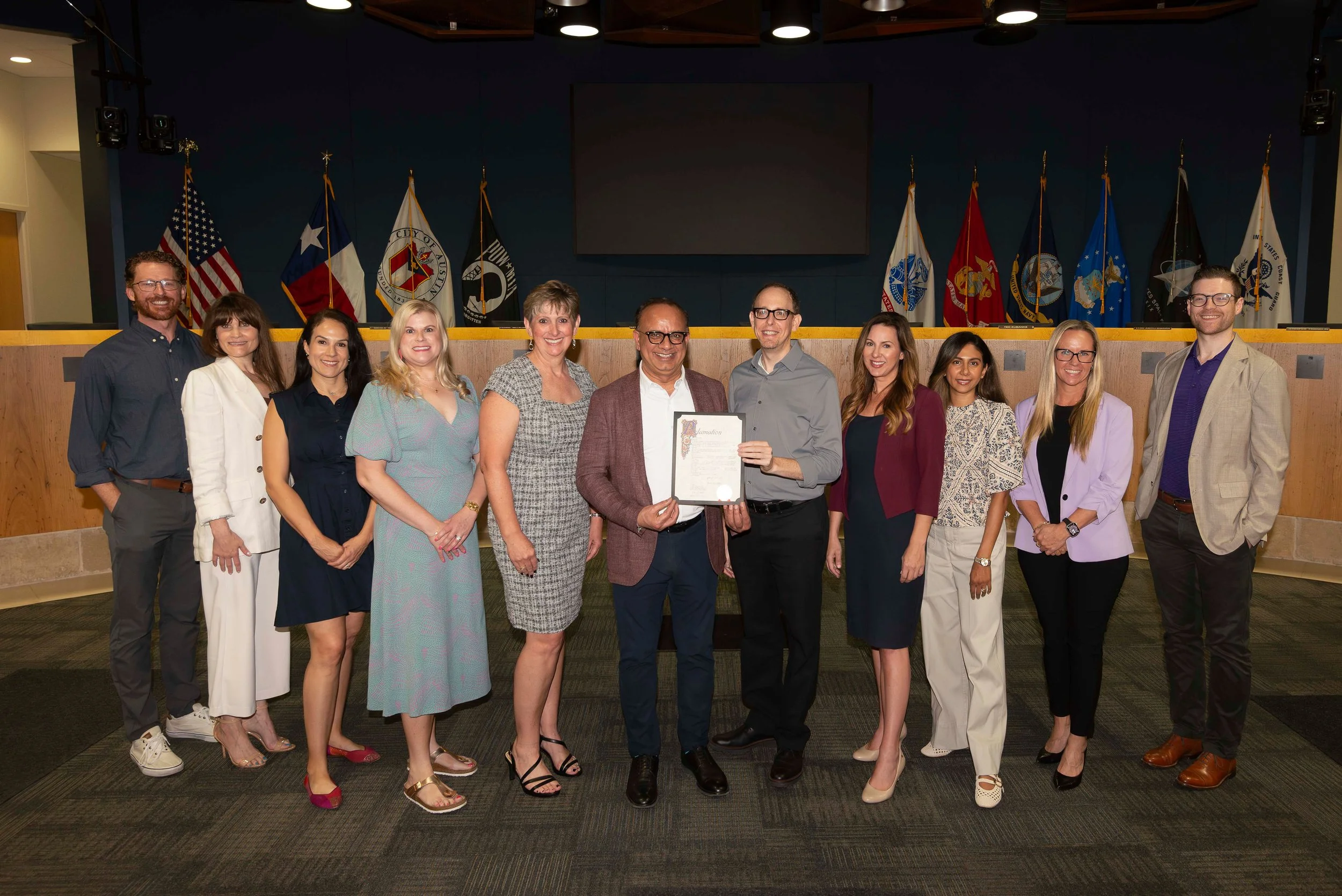 A group of Gastroenterology clinicians receiving a proclamation from City of Austin District 10 Council Member Marc Duchen recognizing IBS awareness day