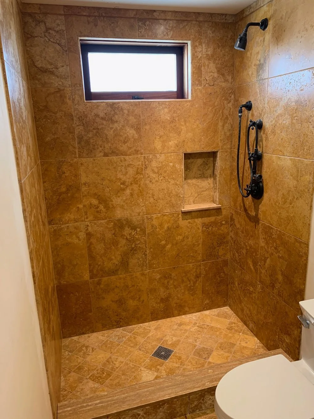 Custom Travertine Shower 
 
A custom travertine shower remodel offers a luxurious and timeless addition to any bathroom.
