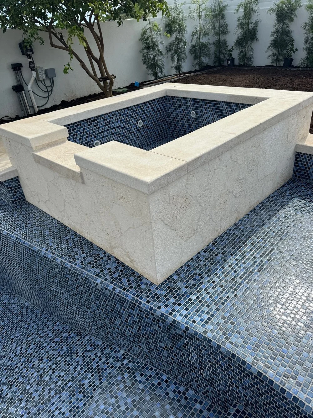 Jacuzzi with Natural Stone and Small tiles 
 
Our installation process is tailored to your jacuzzi area's layout and style, ensuring every detail complements your home while maintaining high-quality craftsmanship.