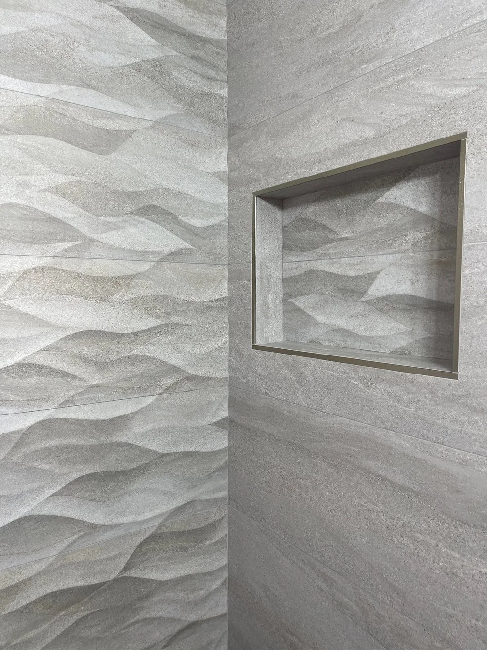 Shower Remodel with Textured Tiles 
 
Wavy porcelain tile brings a modern look to a shower remodel, adding visual interest and texture.