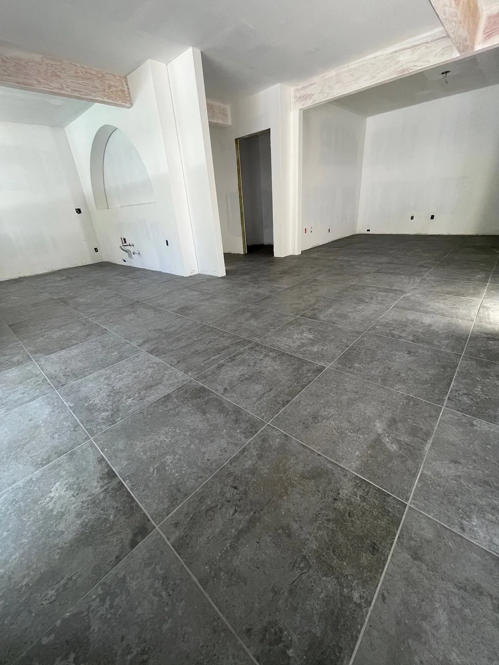 Large Format Tile Floor Remodel  
 
Professionals ensure precise installation of large format tiles to achieve a flawless finish.