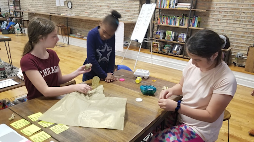 Redwood Day students using teamwork to build their sea turtle eggs.