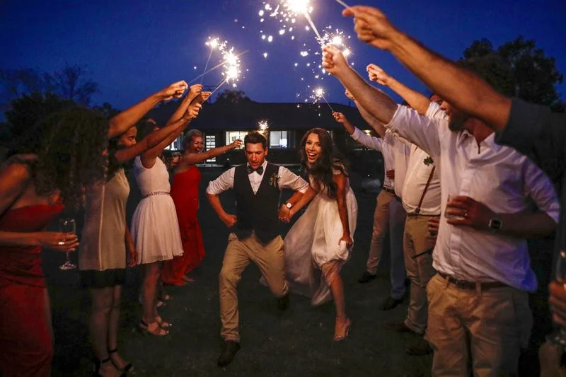 Bride and Groom Having Fun With Sparklers