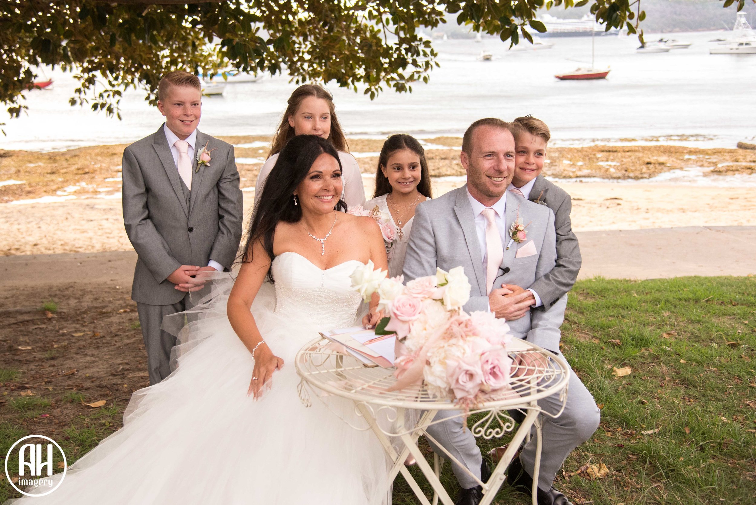 Bride and Groom with their children signing the register at their wedding
