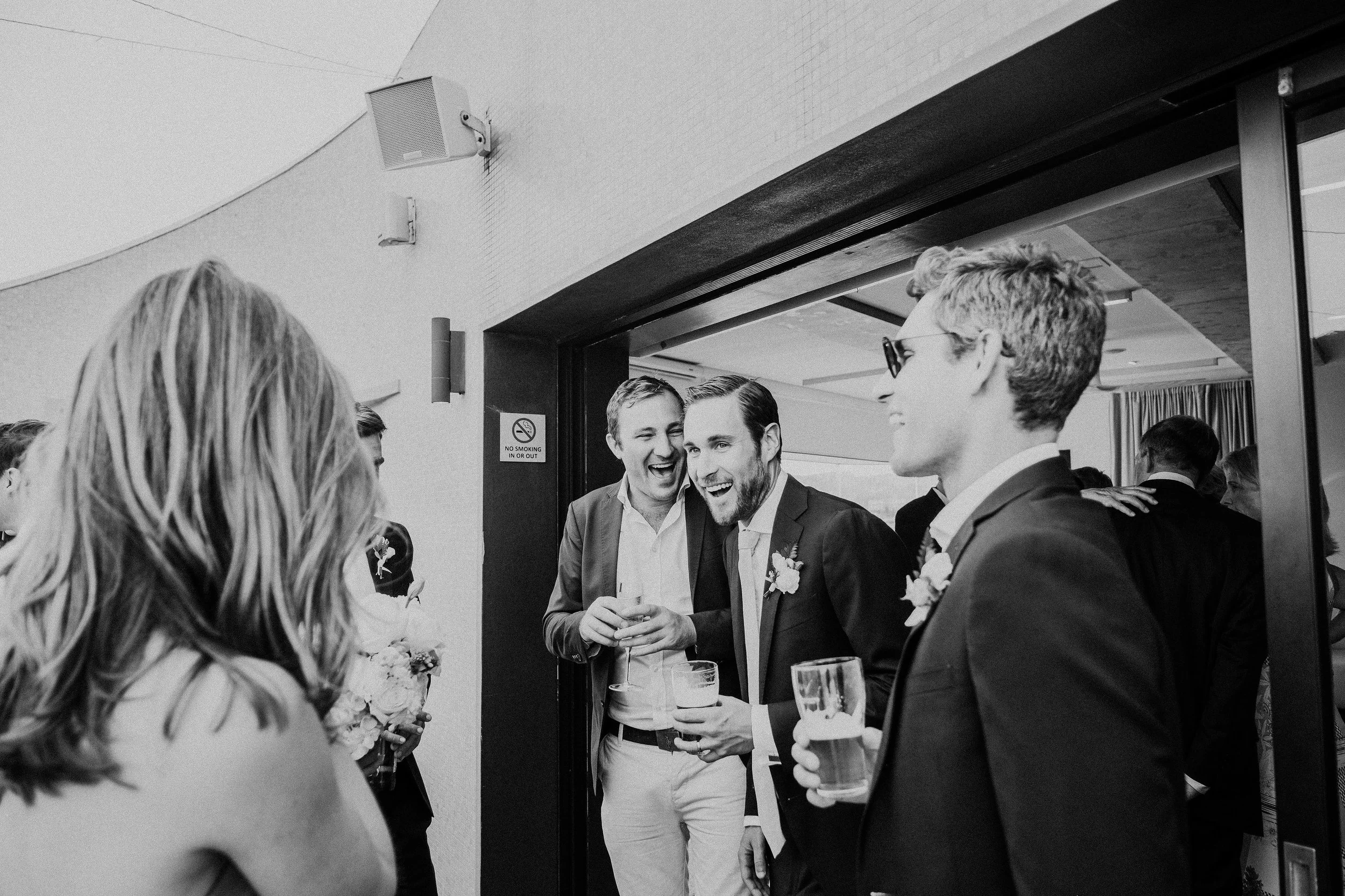 Groom laughing with wedding guests at North Bondi Surf Club Wedding