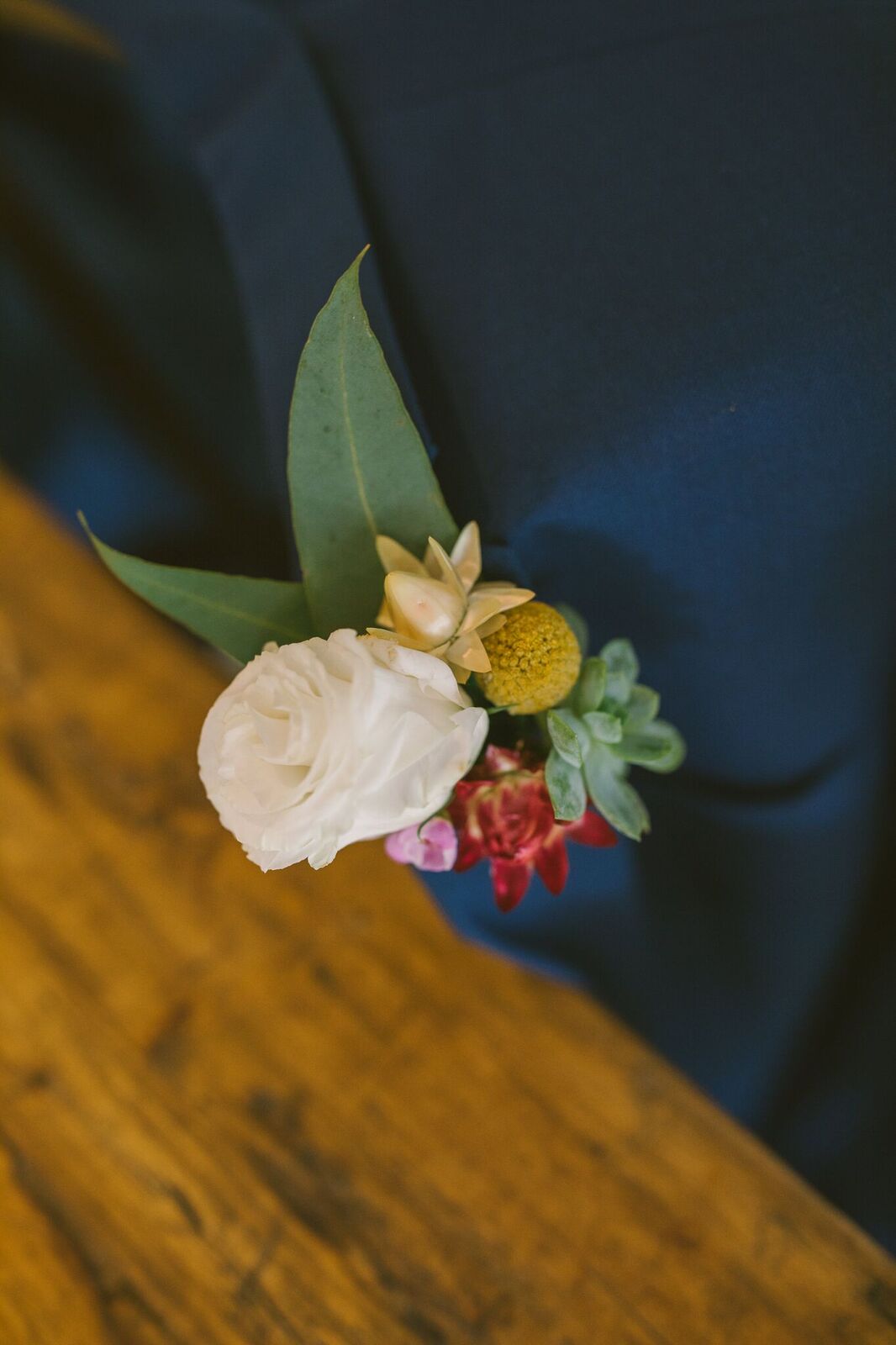 Grooms button hole with white flowers and native wedding flowers