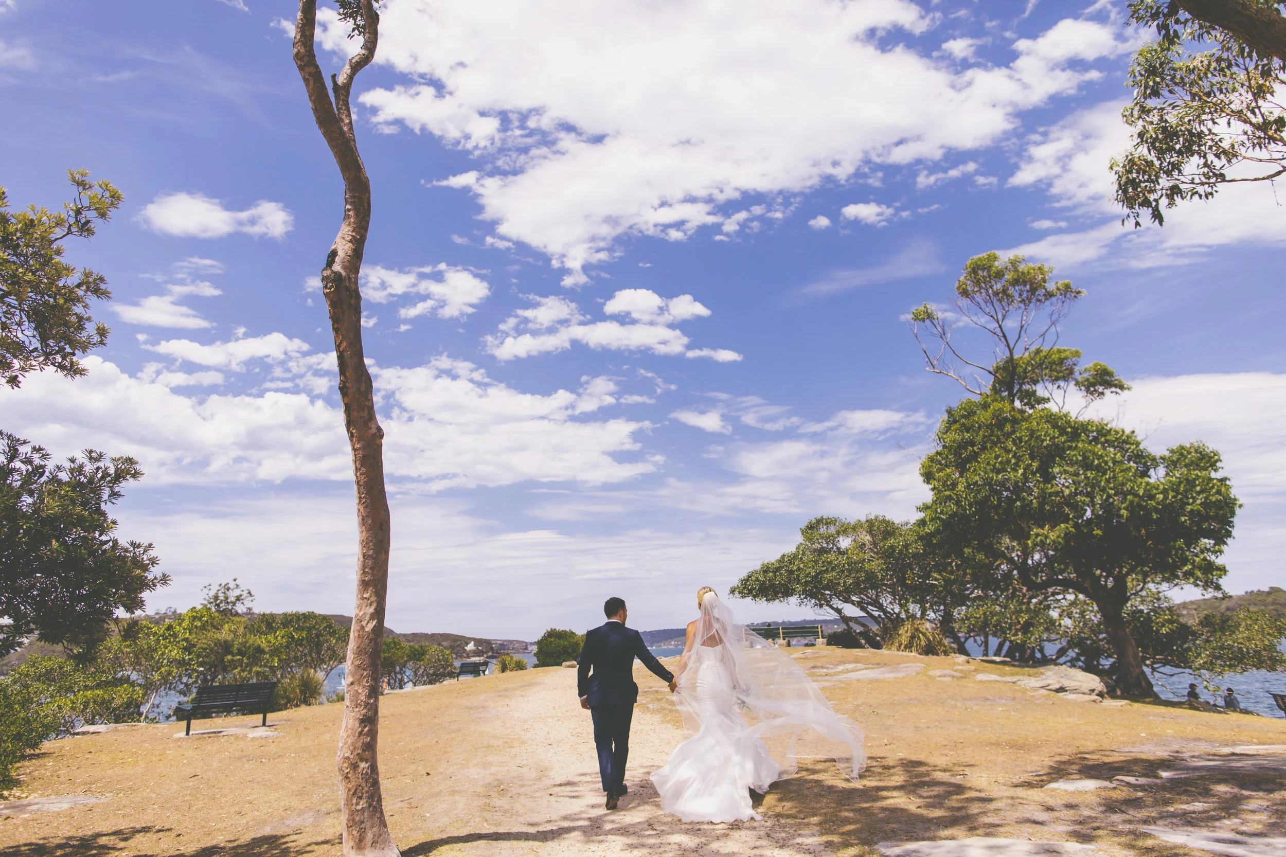 Bride and Groom getting Wedding photos at Balmoral Beach