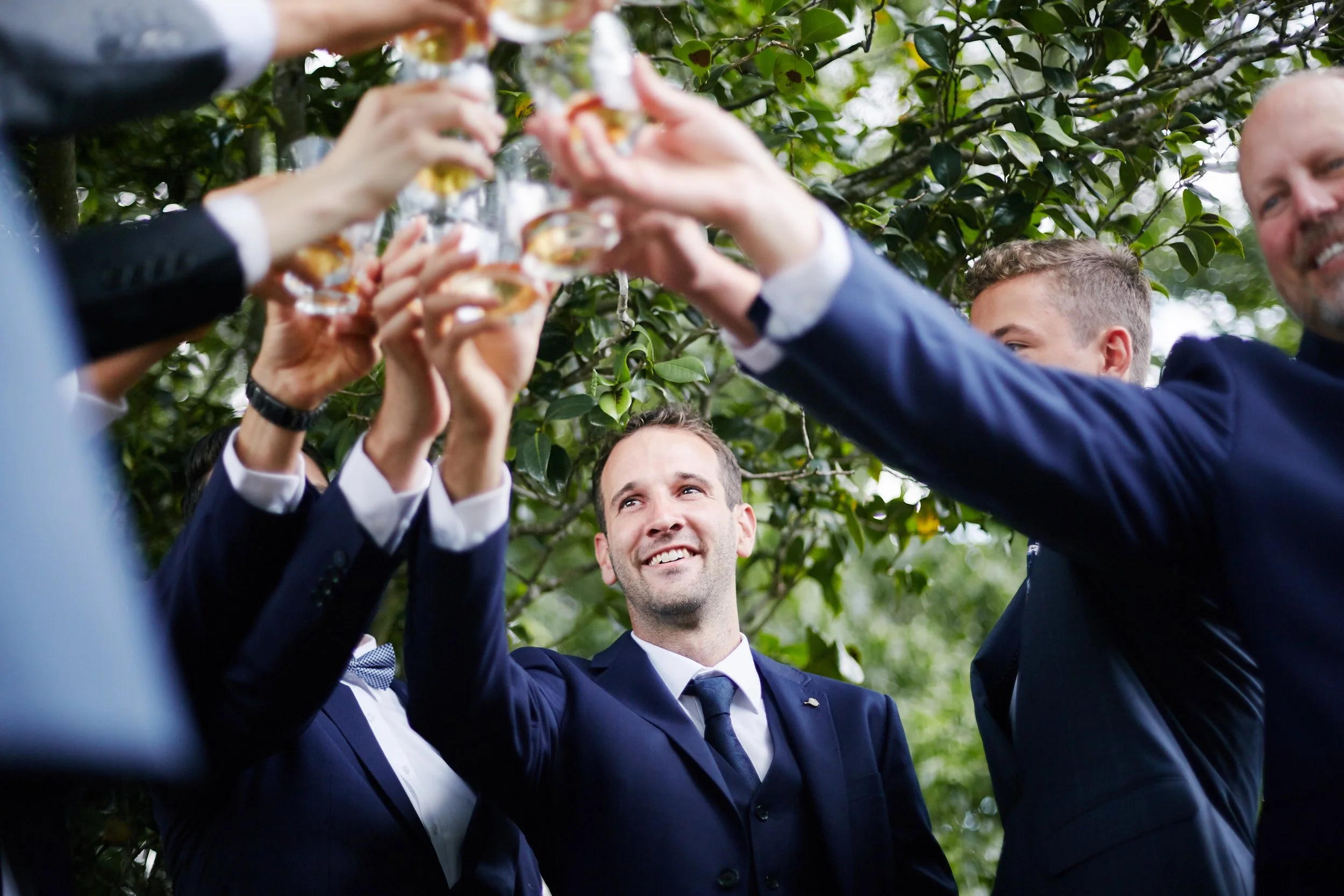 Grooms toasting drinks before the wedding starts