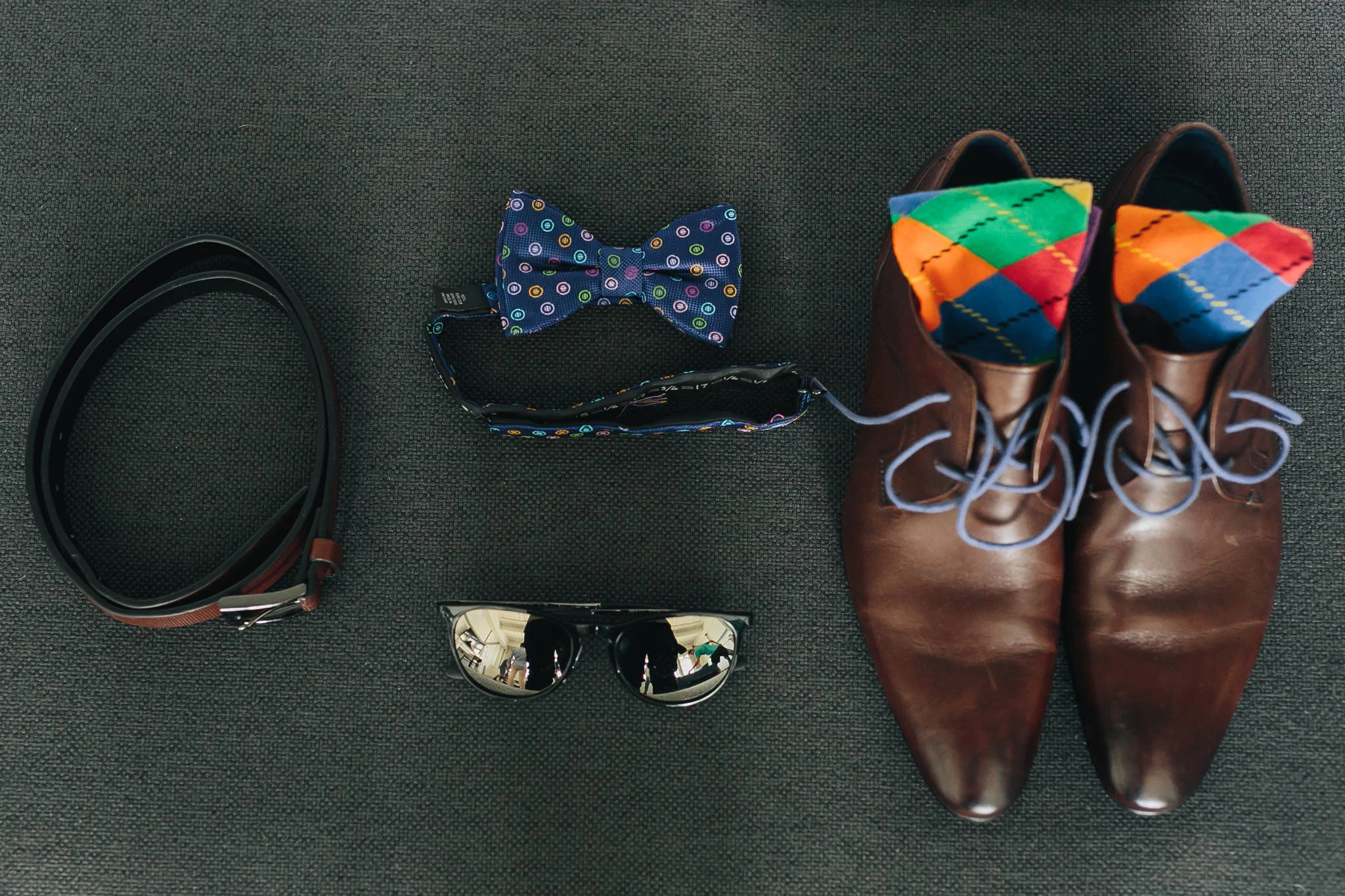 Grooms bow tie, shoes and accessories displayed for a wedding photo