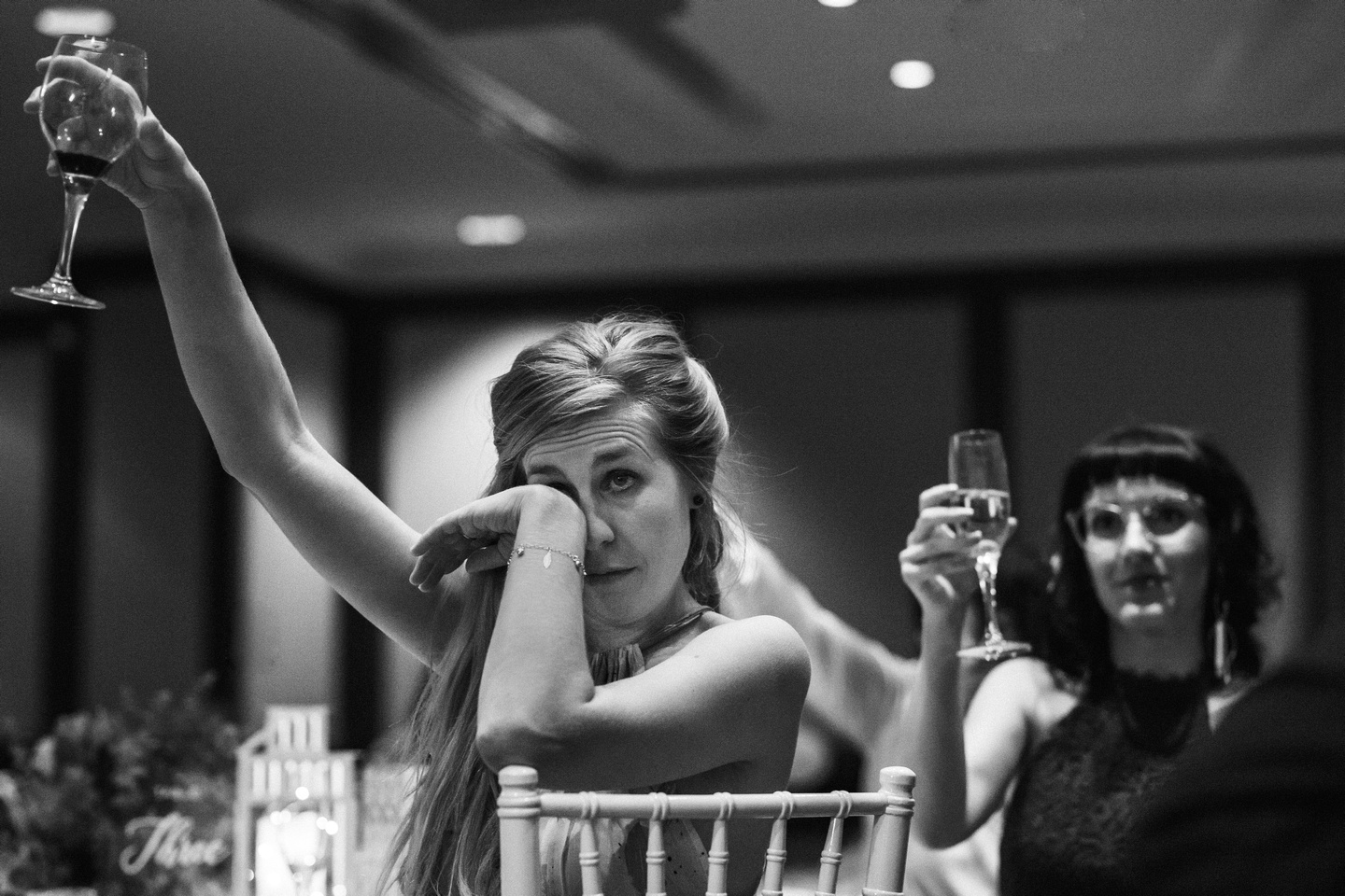 Wedding guests raising their glasses for a wedding toast at Shangri-La Sydney