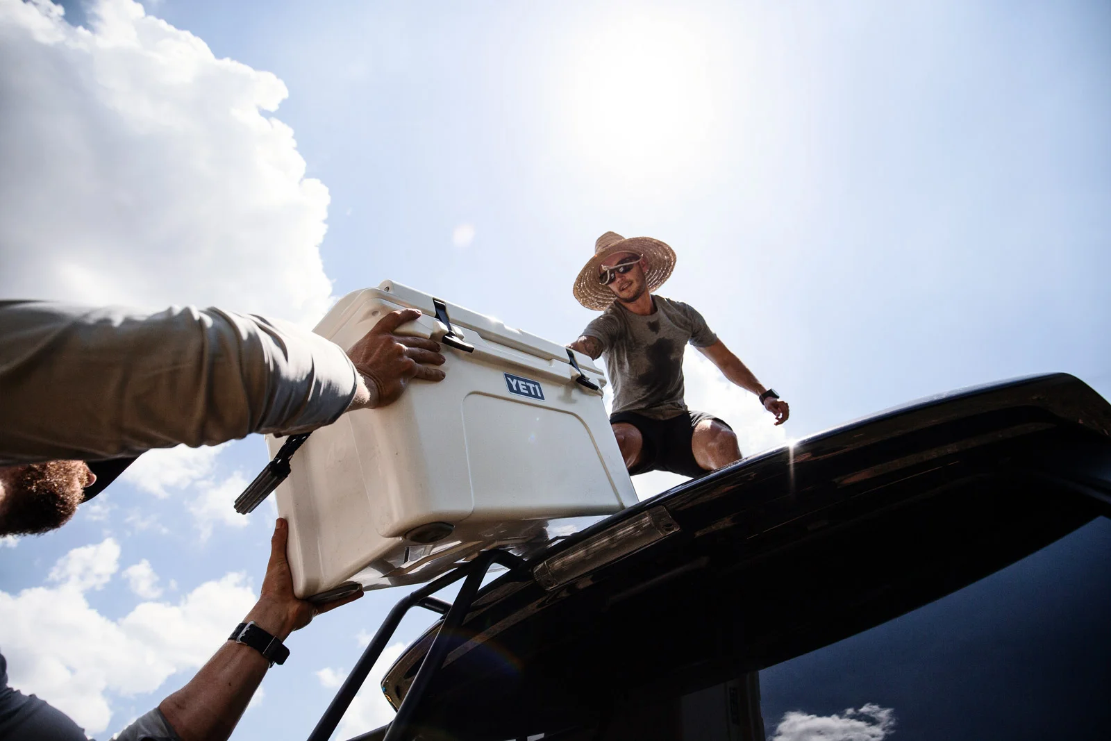 Loading cooler onto 4runner car roof outdoor adventure