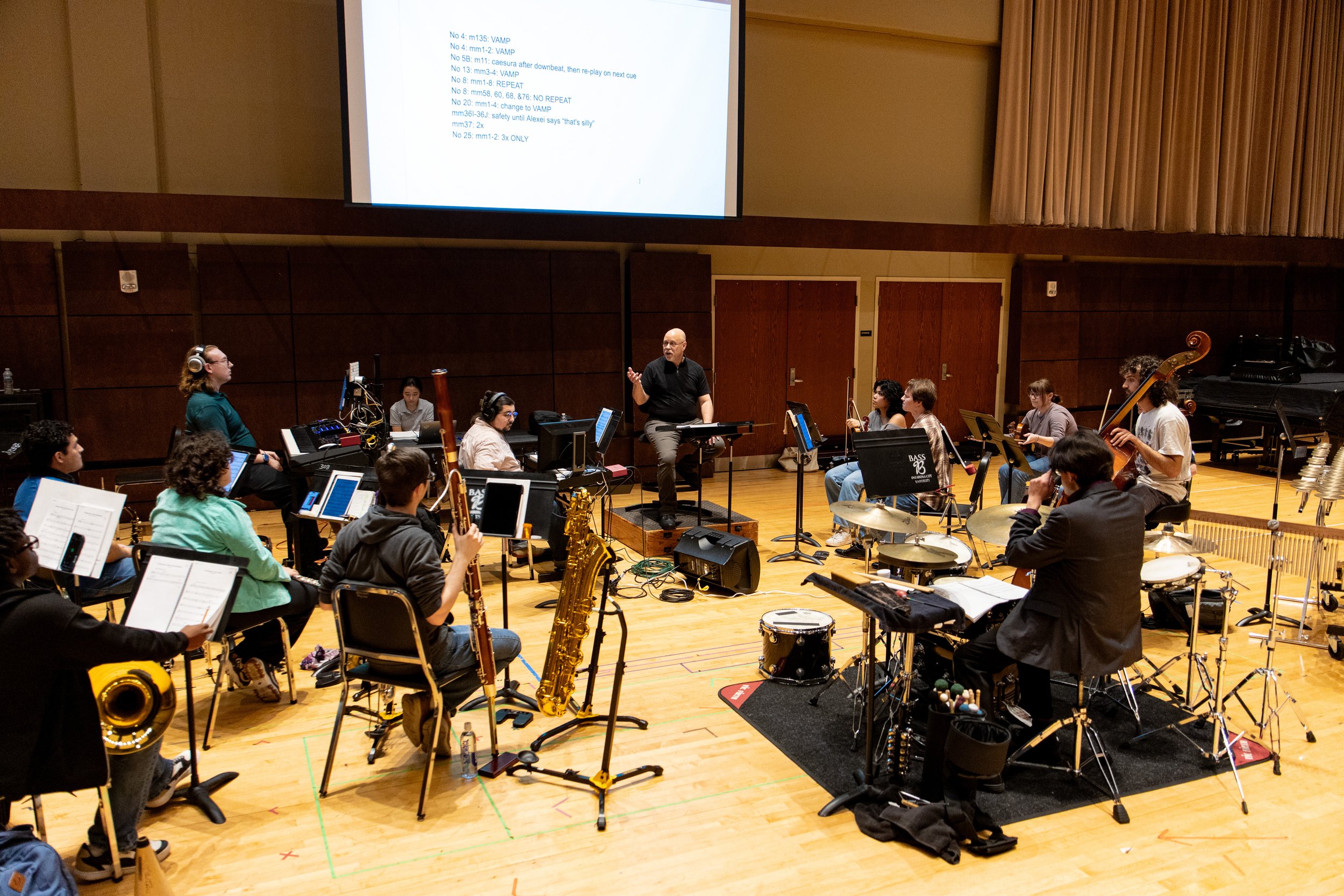 Multiple Woodwinds students rehearsing in the "Anastasia" pit with Dr. Mailman