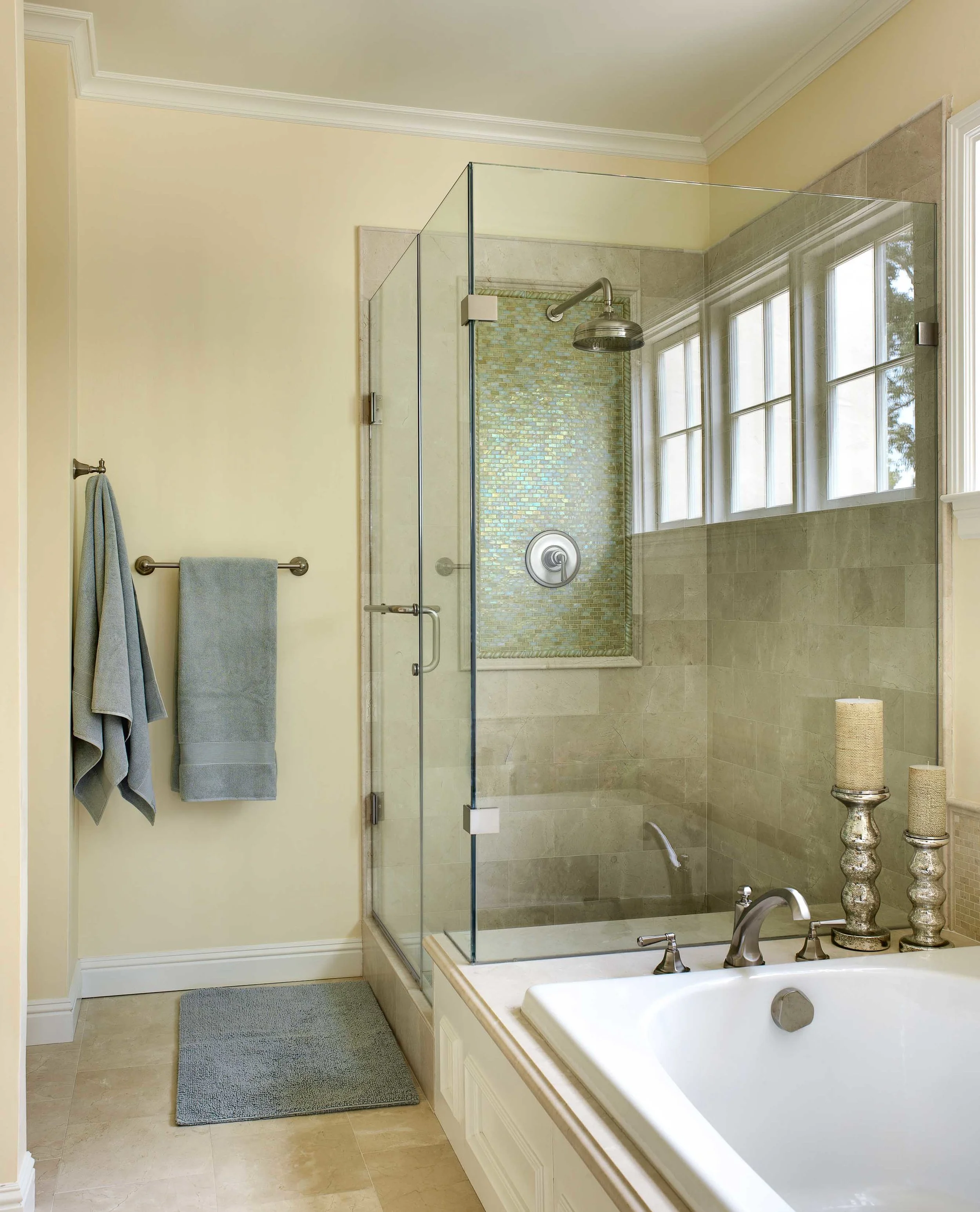 San Mateo Park pale, yellow bathroom with clear shower doors. Jana Magginetti Interior Design