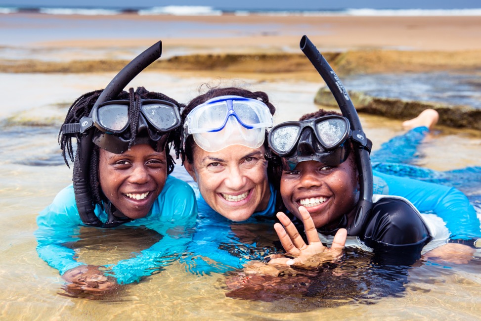 Hanli Prinsloo, Founder & CEO of I AM WATER, with young participants in I AM WATER’s ocean experiences program. Photo credit: Charlie Dailey.