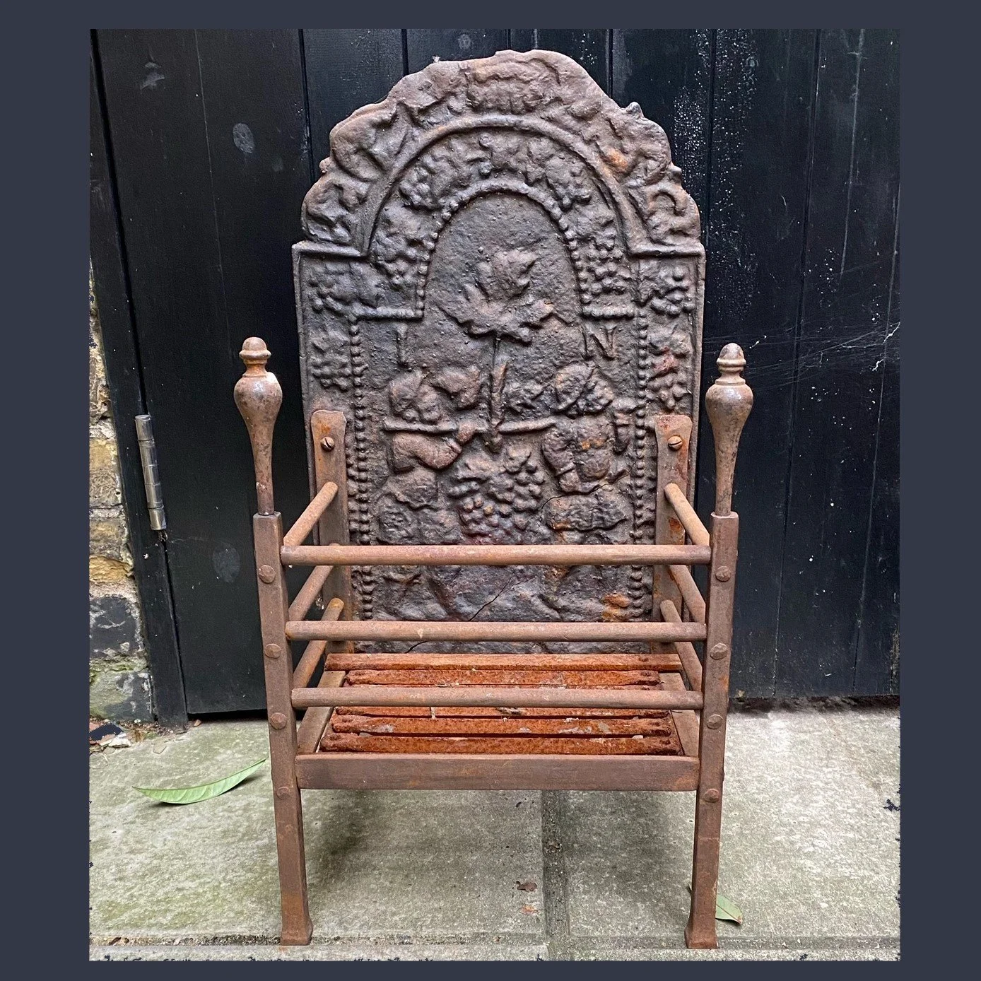 A 19th century wrought and cast iron fire grate