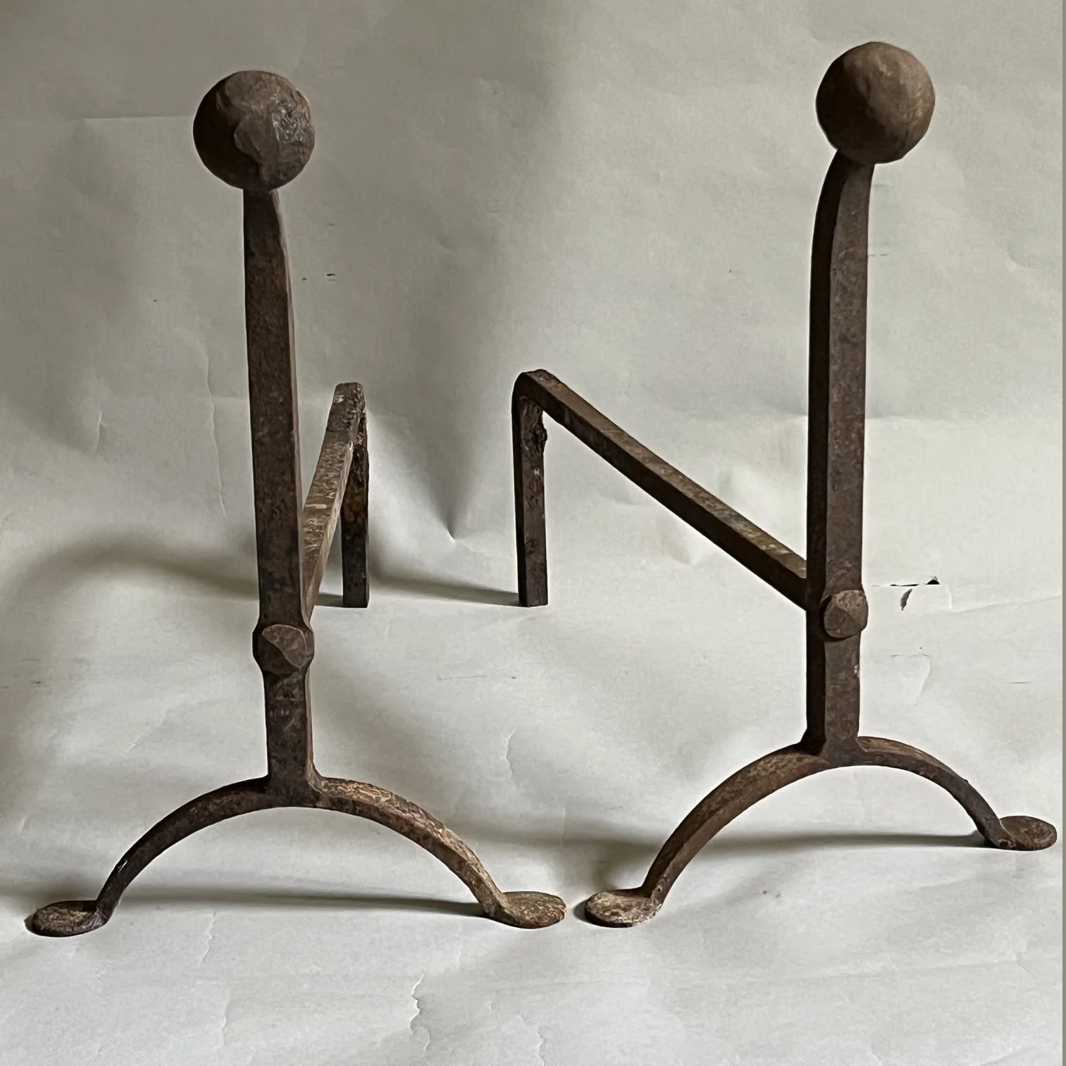 A pair of early 20thc English wrought iron andirons