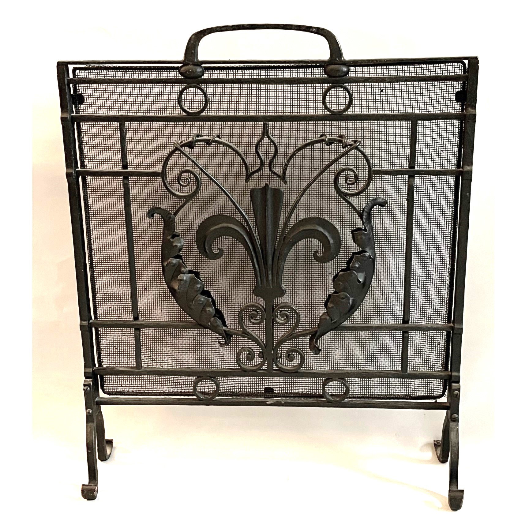 A blacksmith made wrought iron and wire mesh firescreen