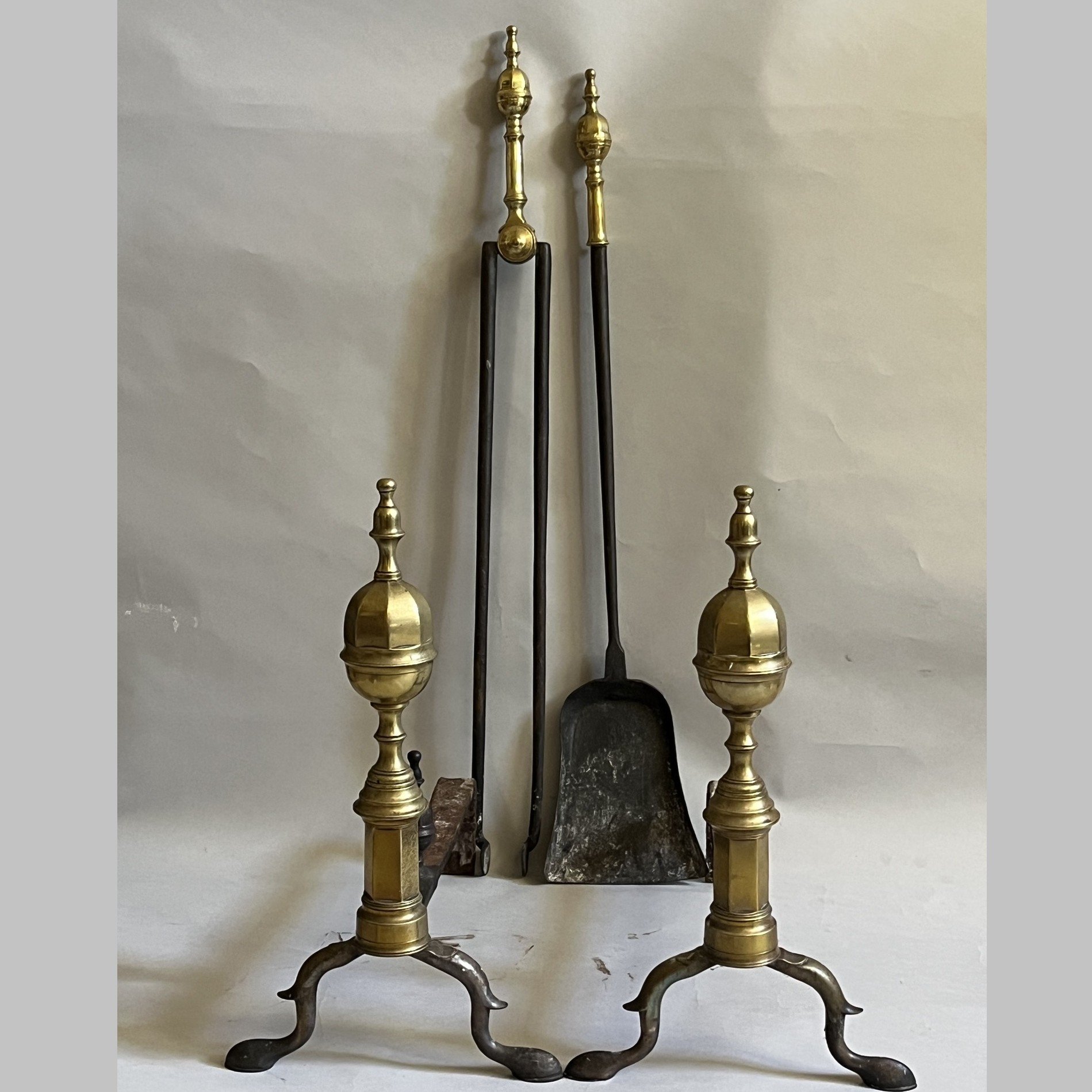 A pair of early 19th century American brass andirons with matching firetools. Stamped Molineux, Boston