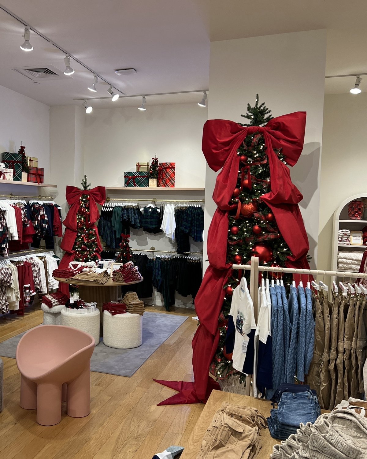 Custom oversized red velvet bow holiday tree topper, retail holiday display installation, Gymboree