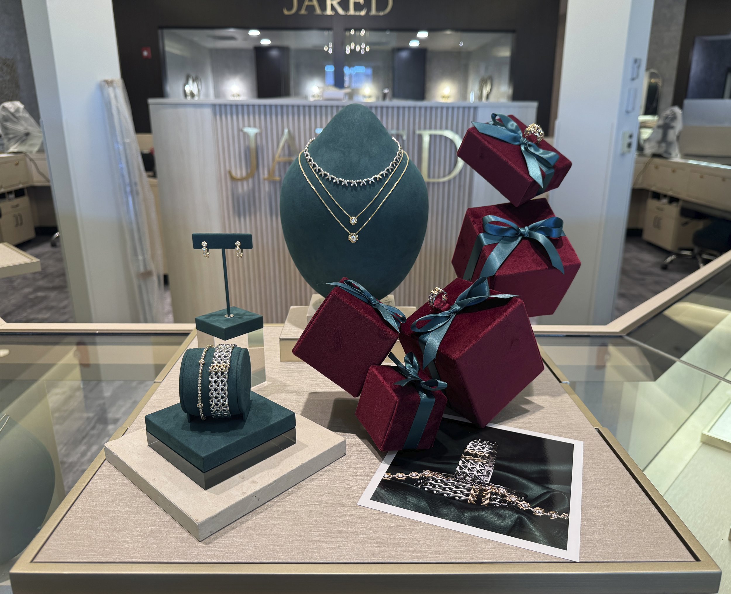 Custom burgundy velvet jewelry display forms with ribbons Jared Jewelers retail display