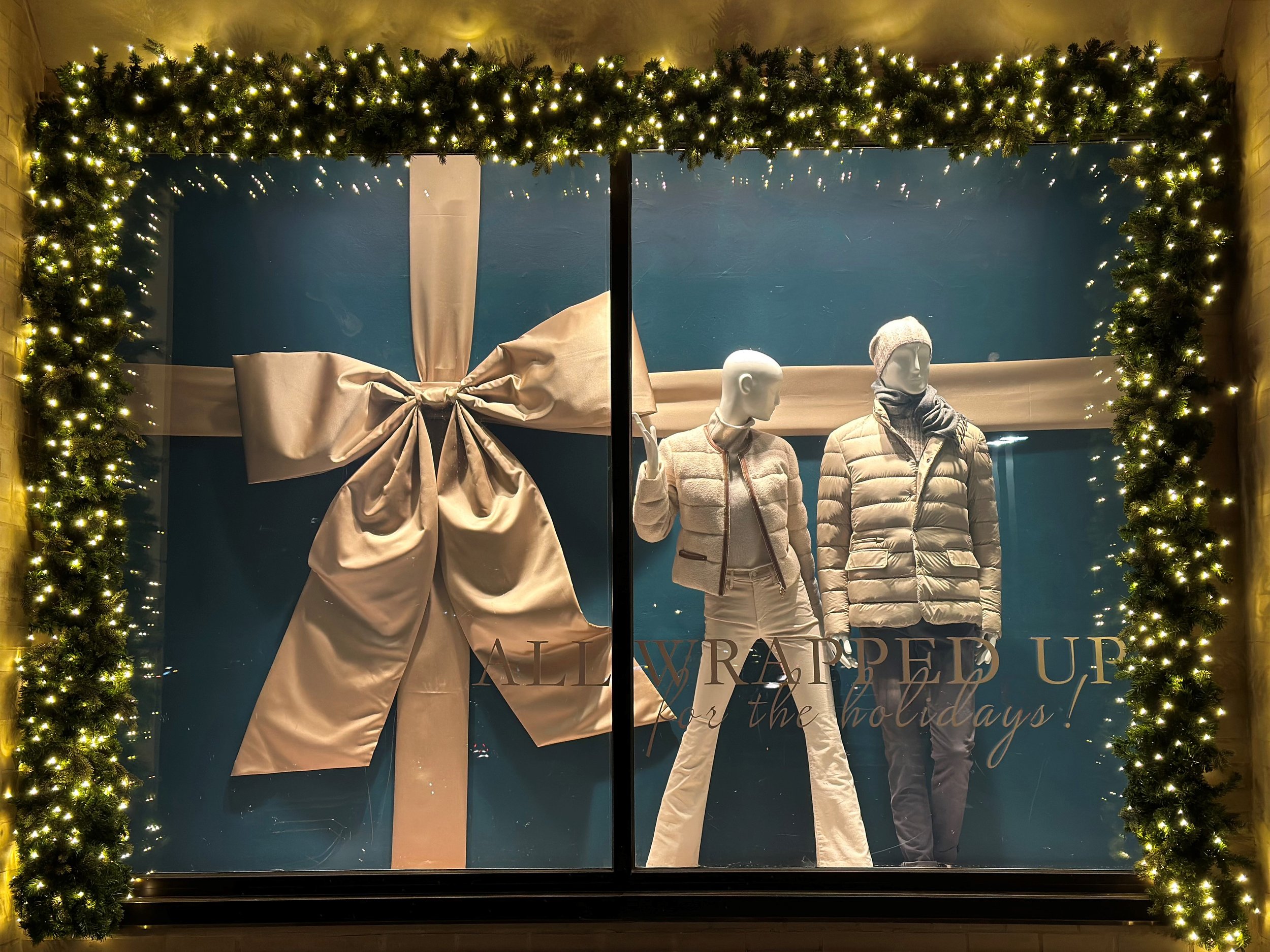 Custom oversized satin bow holiday window display installation, Mitchell's retail storefront