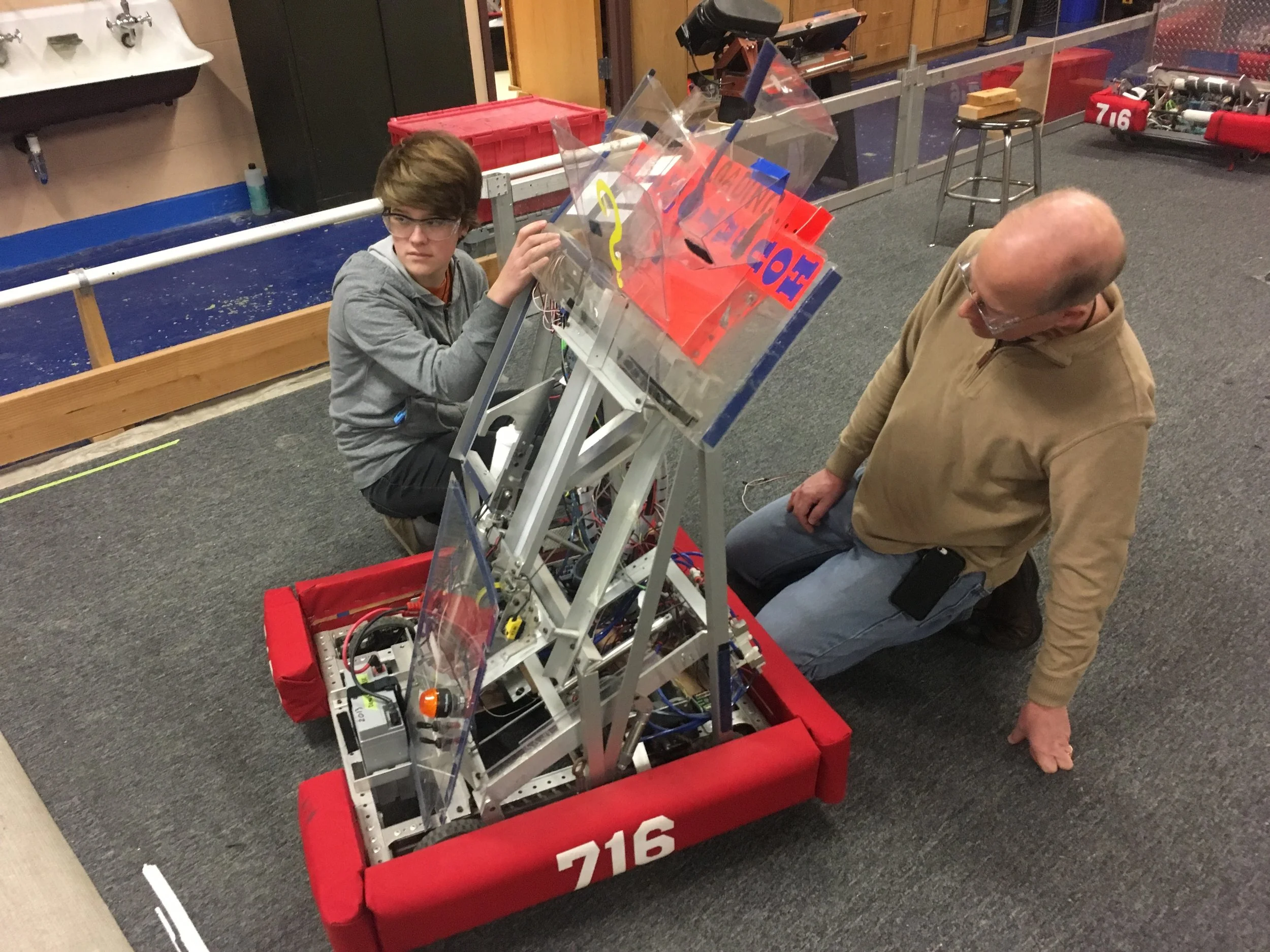 Part of our programming team, rewiring the test robot.