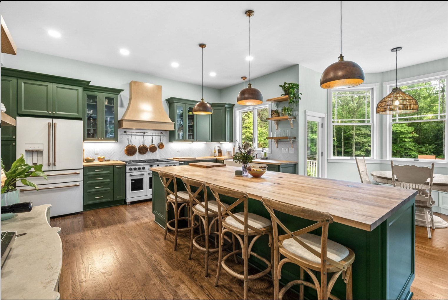 Finished green kitchen remodel with butcher block counters, farmhouse sink and copper fixtures