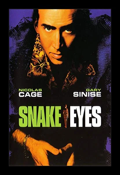 Day 21: Snake Eyes - De Palma teamed up with the GOAT Nic Cage for the first time in Snake Eyes . Cage plays an Atlantic City cop who investigates a conspiracy surrounding the murder of the state secretary at an Atlantic City boxing event.