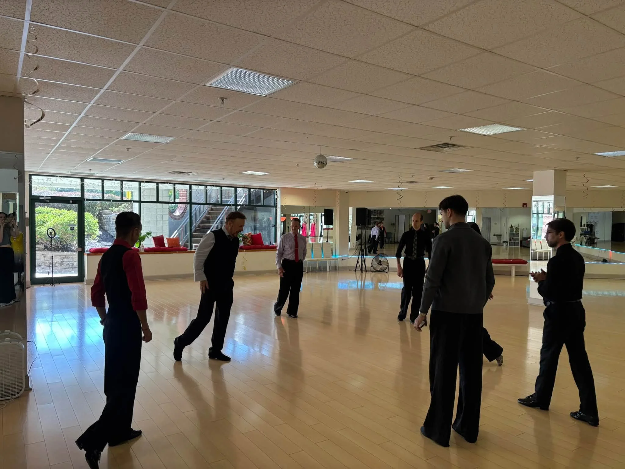 Coaching participants practice together on the Dance Fire studio floor