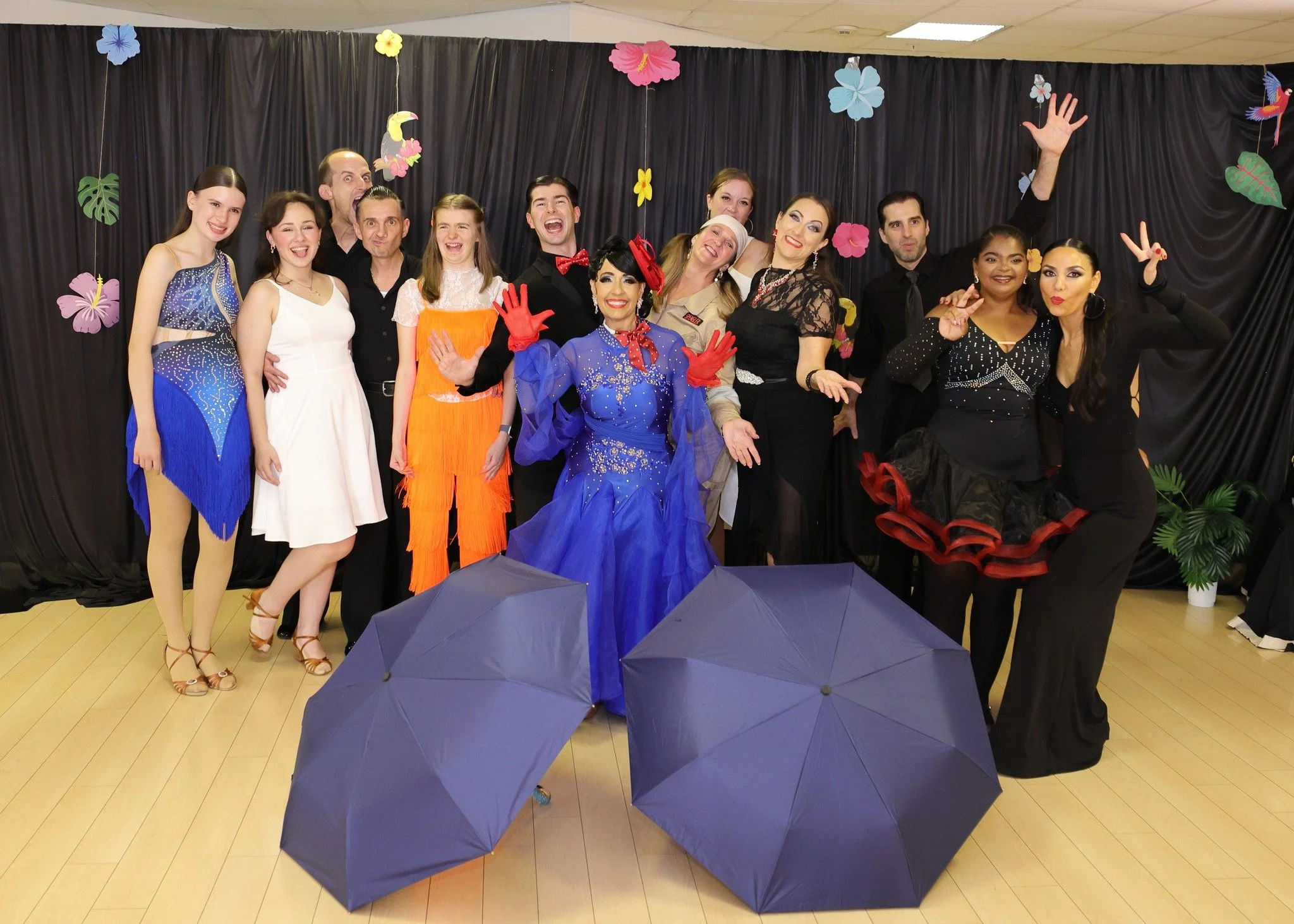 Showcase performers in ballroom dresses pose together at Dance Fire