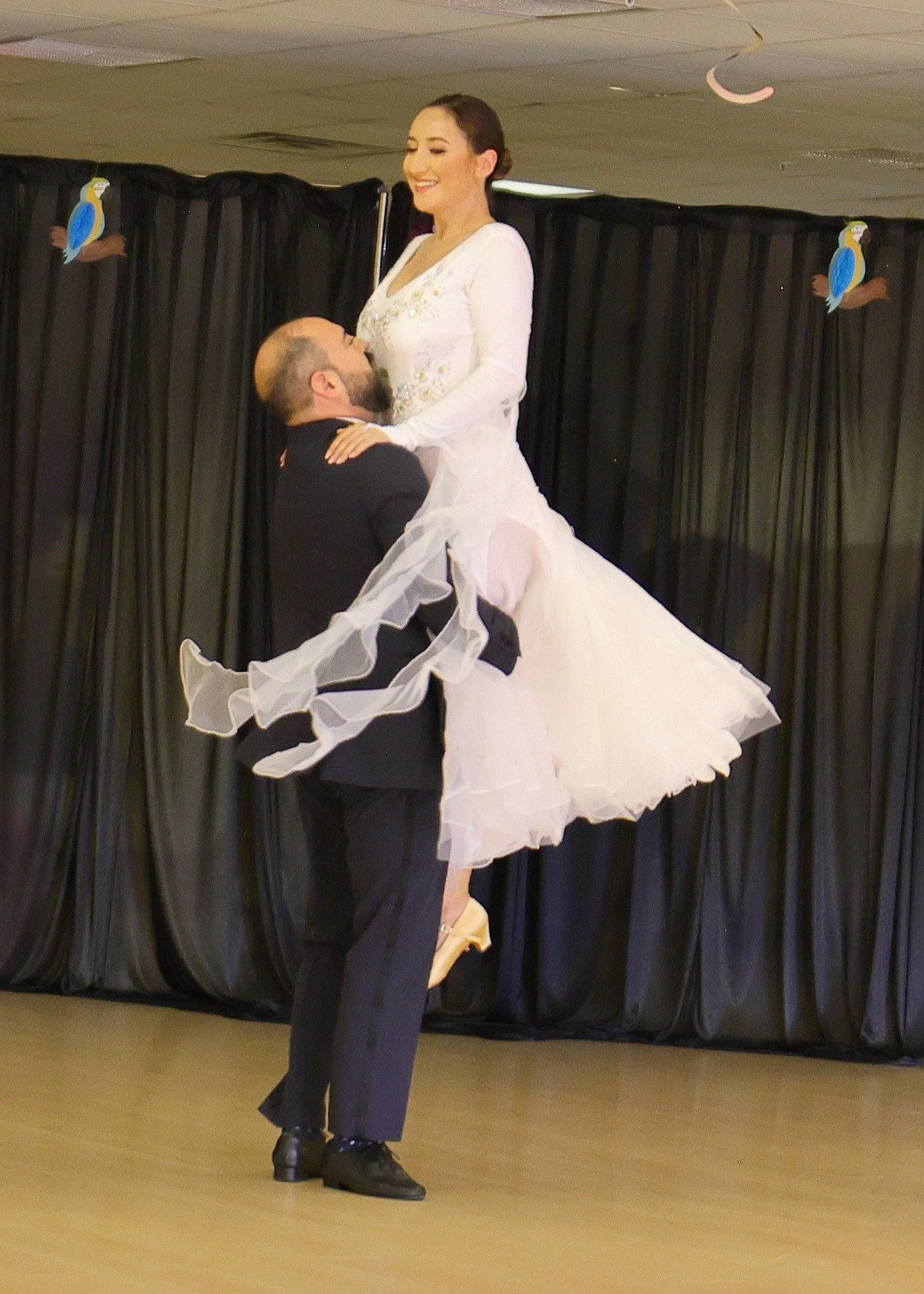 A white ballroom skirt swirls during a Summer Showcase turn