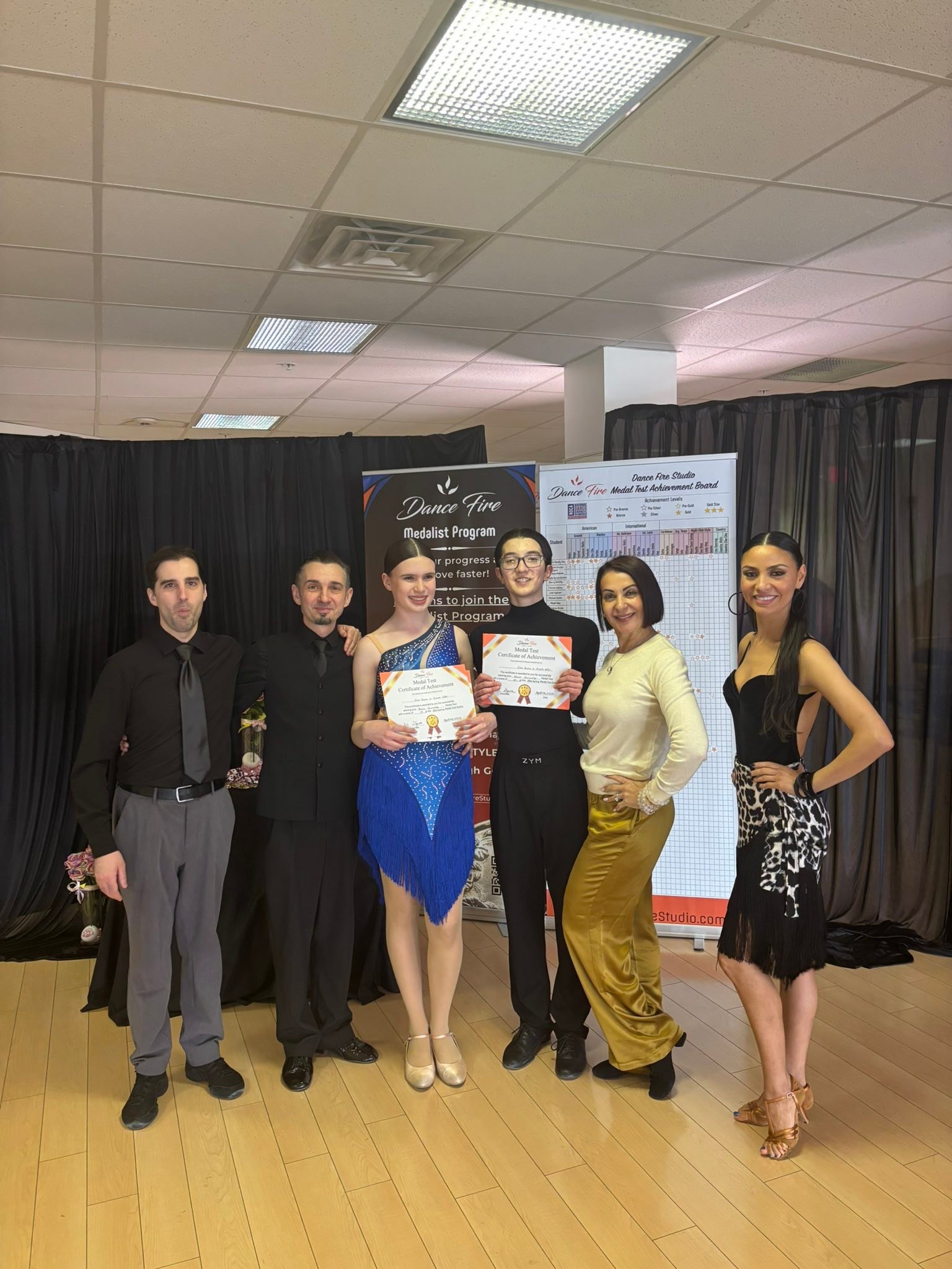A spring event participant poses with the studio team