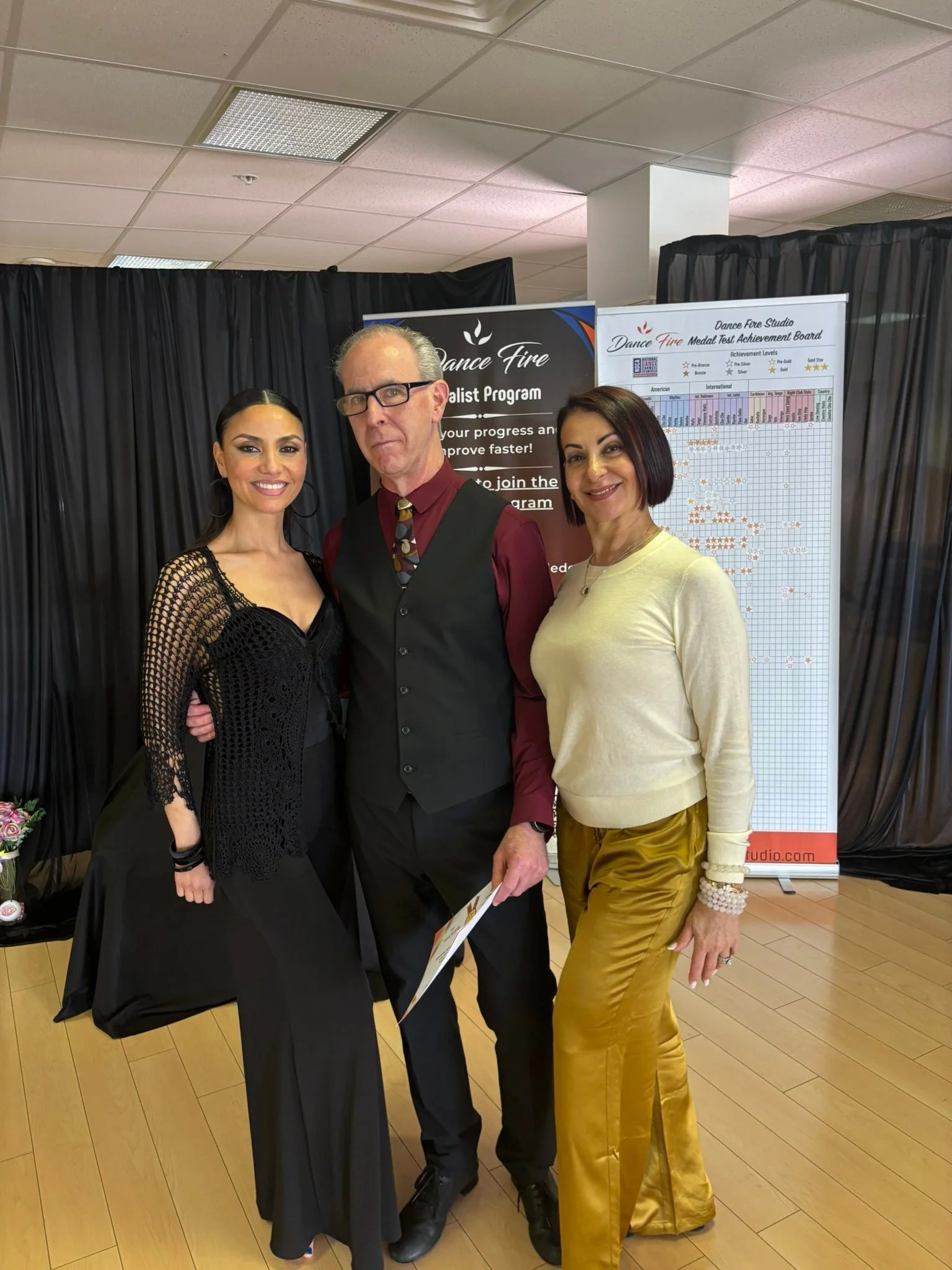 A participant in black dance attire poses with the spring assessment team