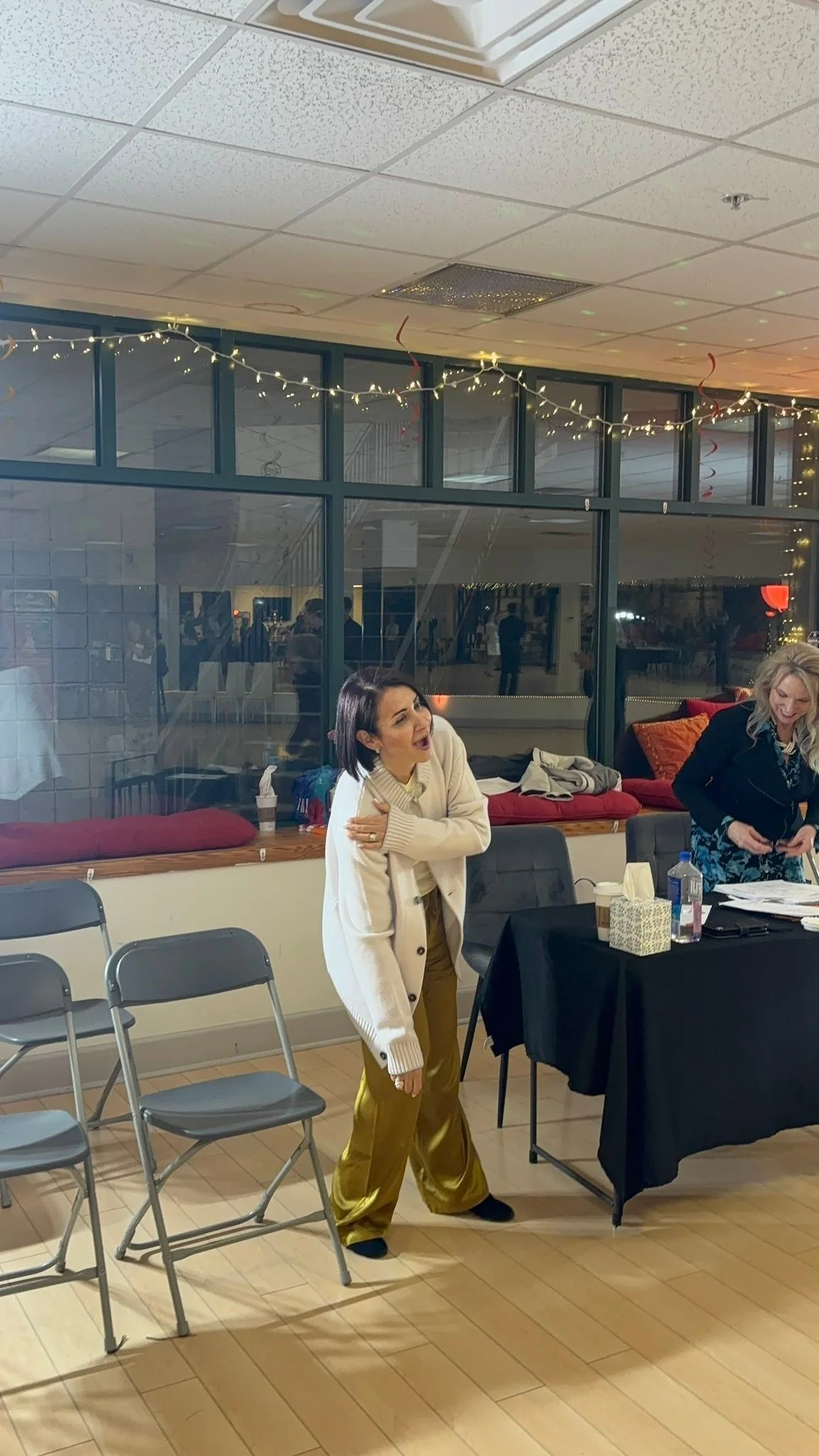 The spring event assessor sits at the studio table beside the dance floor