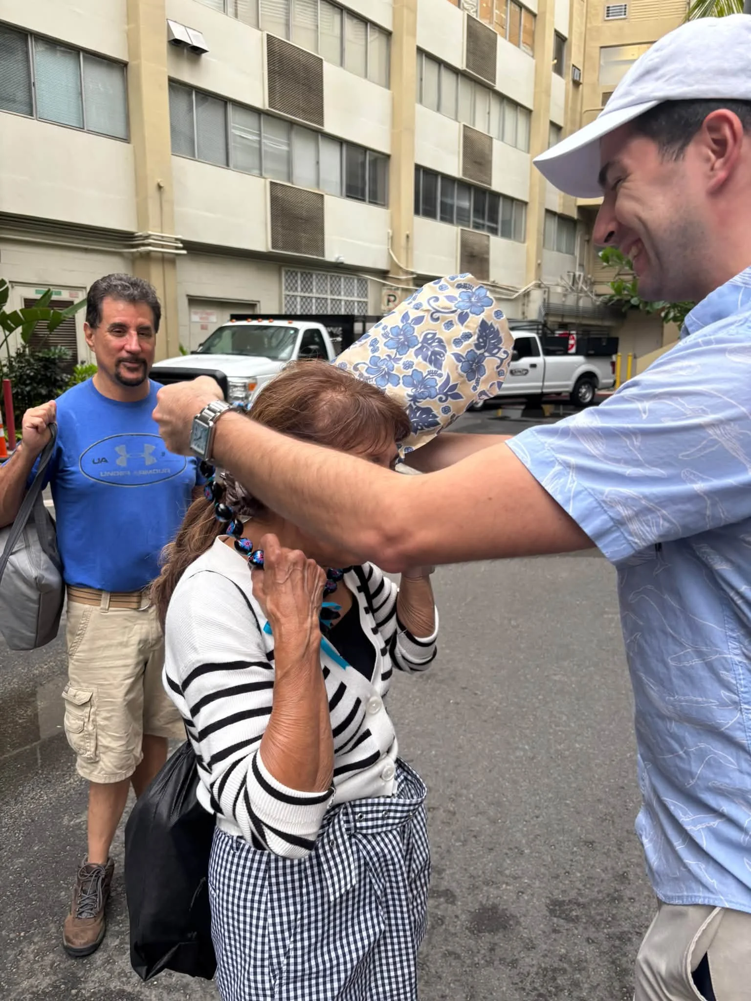 Dance Fire travelers exchange welcome leis outside their Hawaii hotel