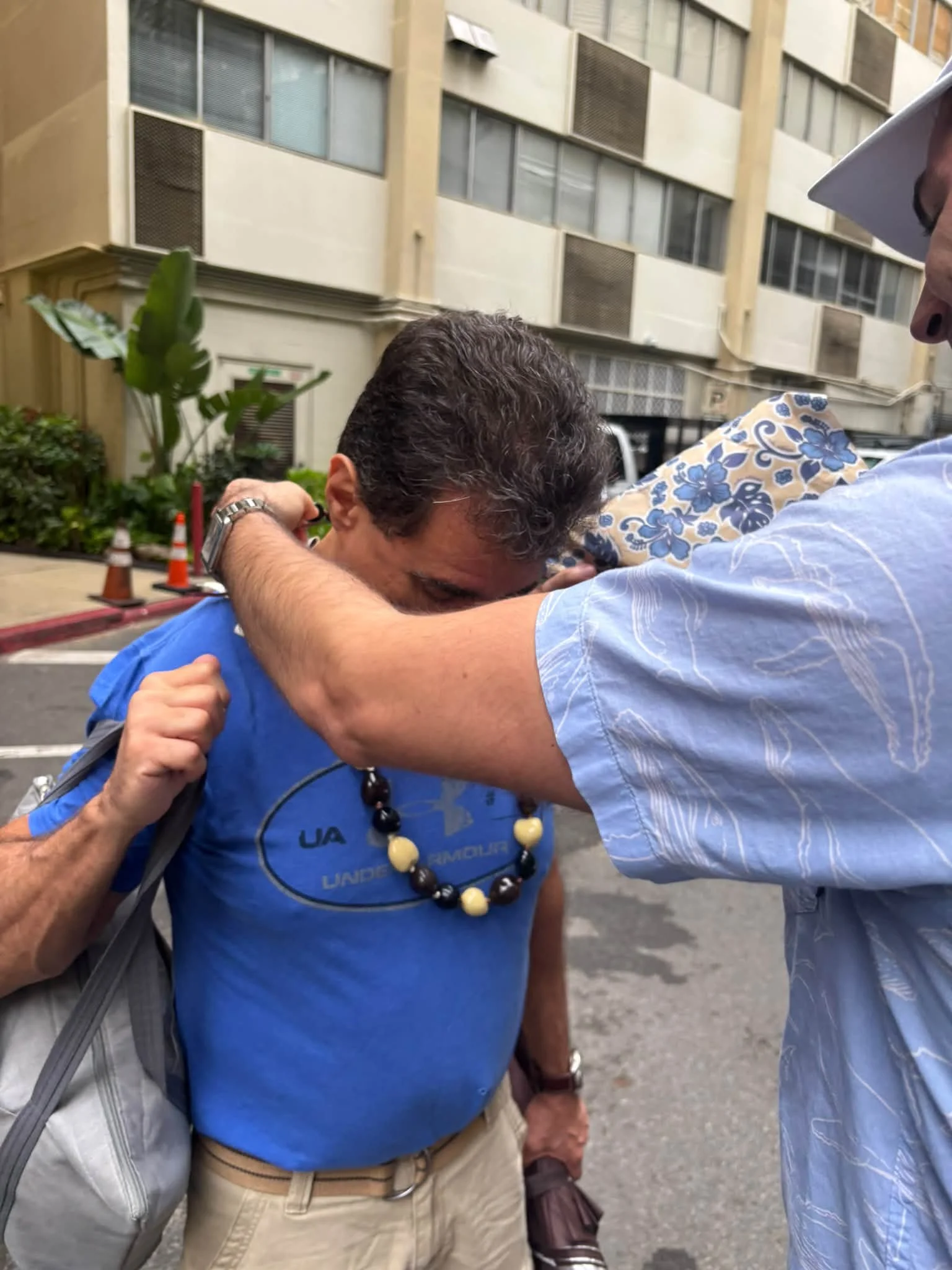 A traveler receives a lei at the start of the Hawaii studio trip