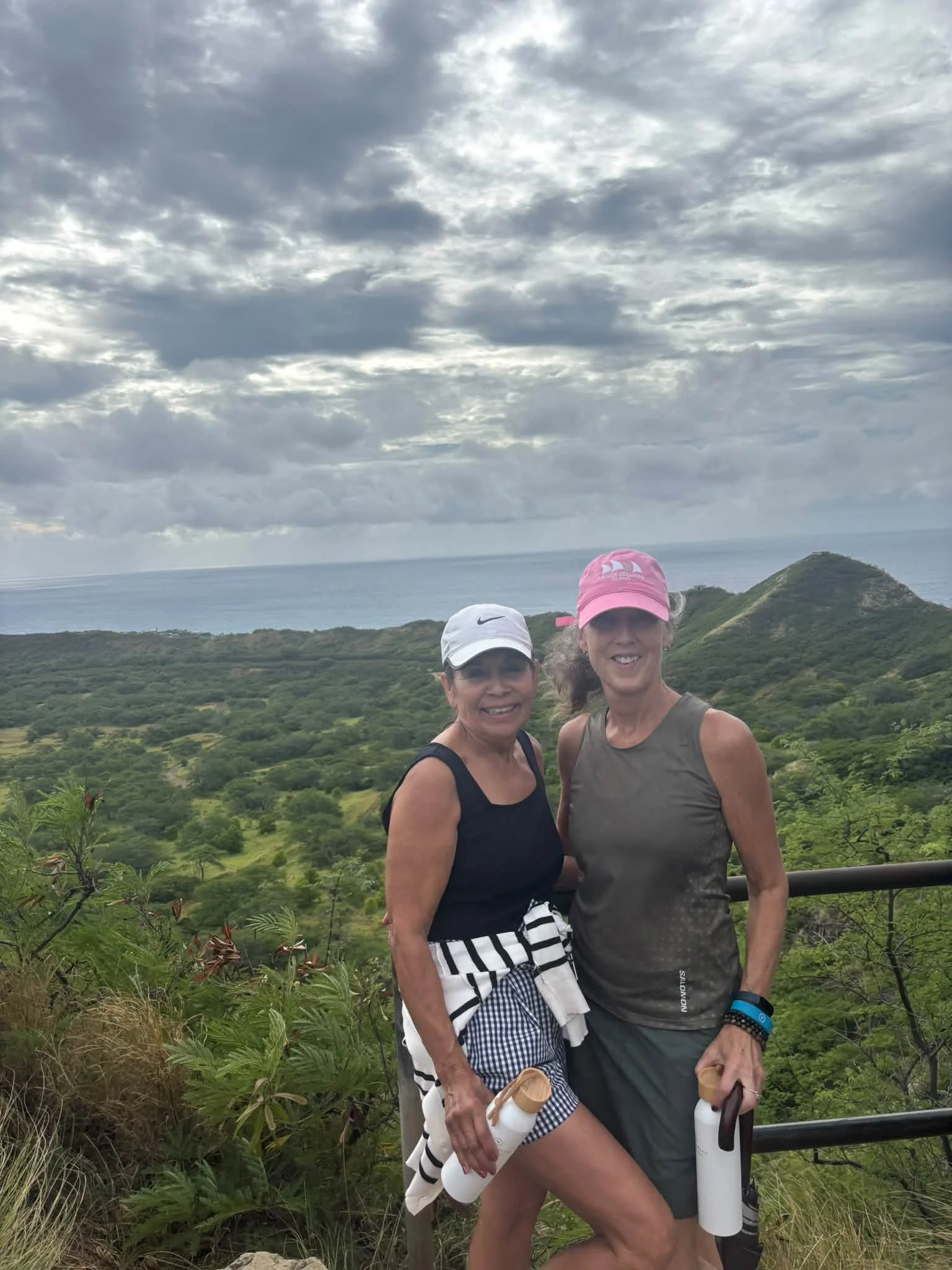 Two Dance Fire travelers pose at a scenic Hawaii lookout