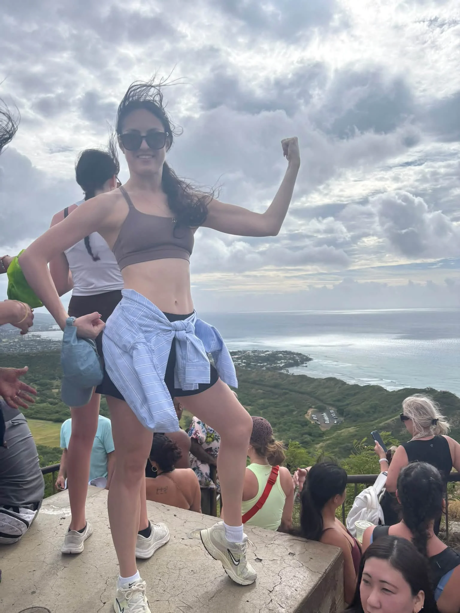 A traveler celebrates reaching a Hawaii lookout