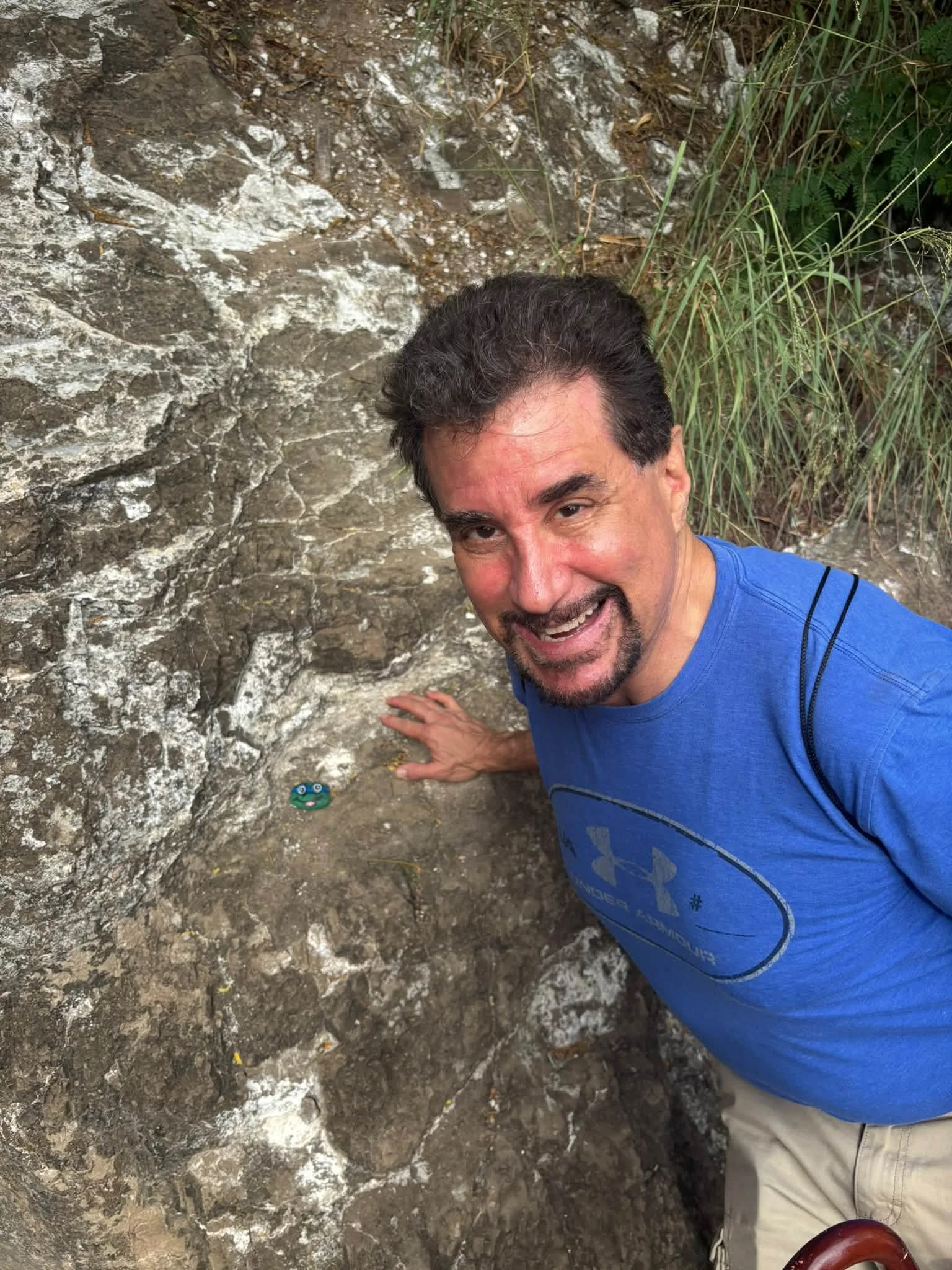 A Dance Fire traveler takes a selfie beside a rocky Hawaii trail