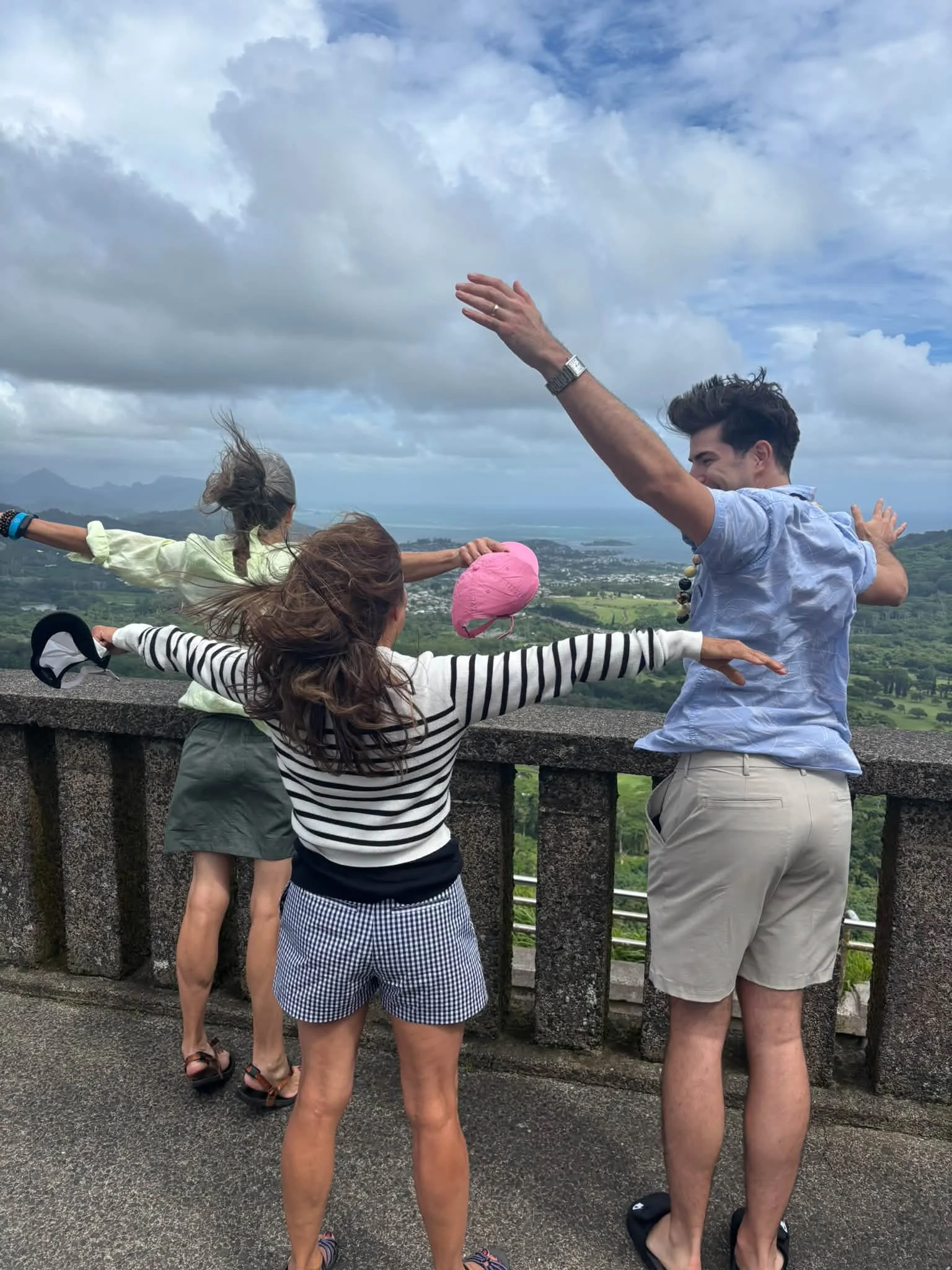 Travelers point toward the view from a Hawaii lookout