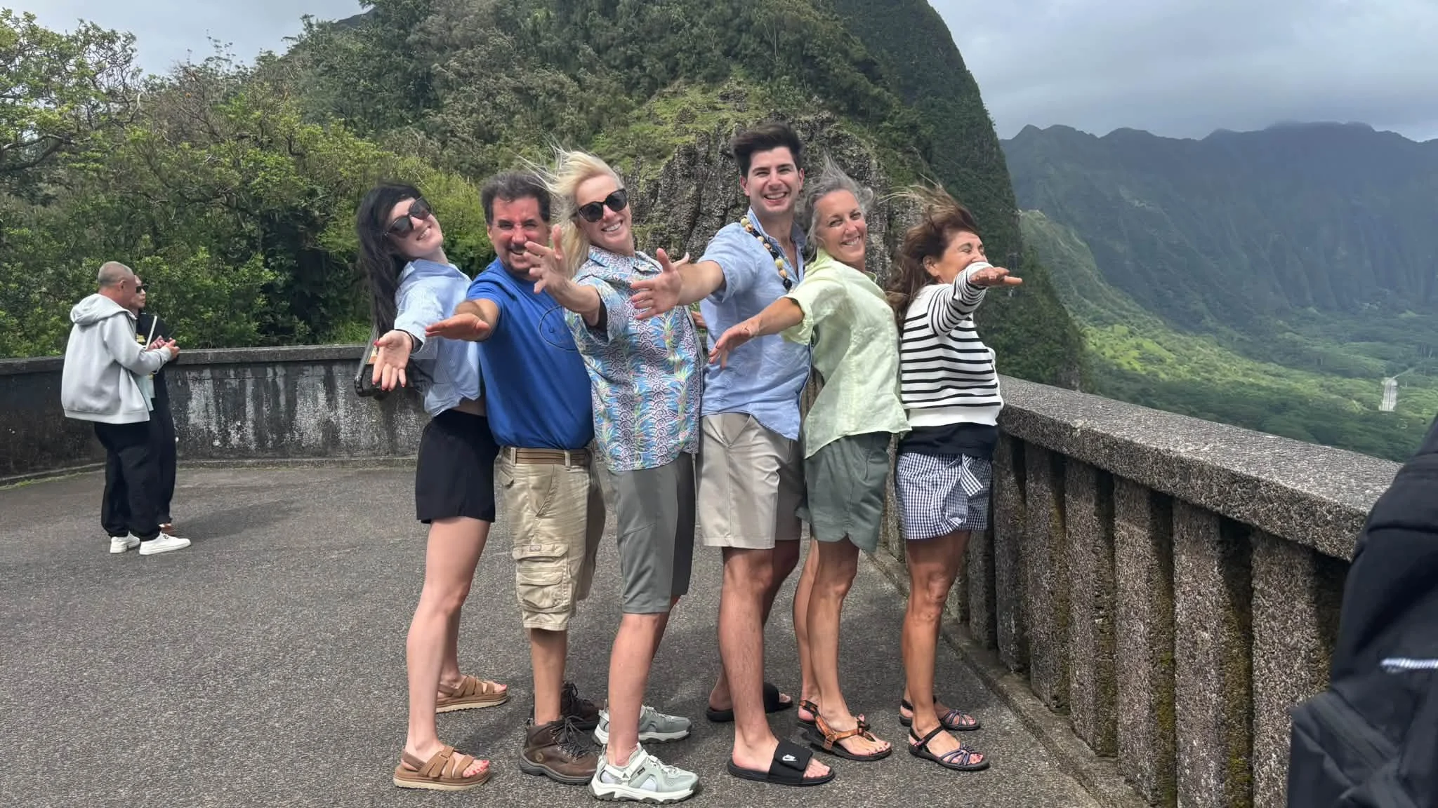 Dance Fire travelers pose together against a green Hawaii hillside